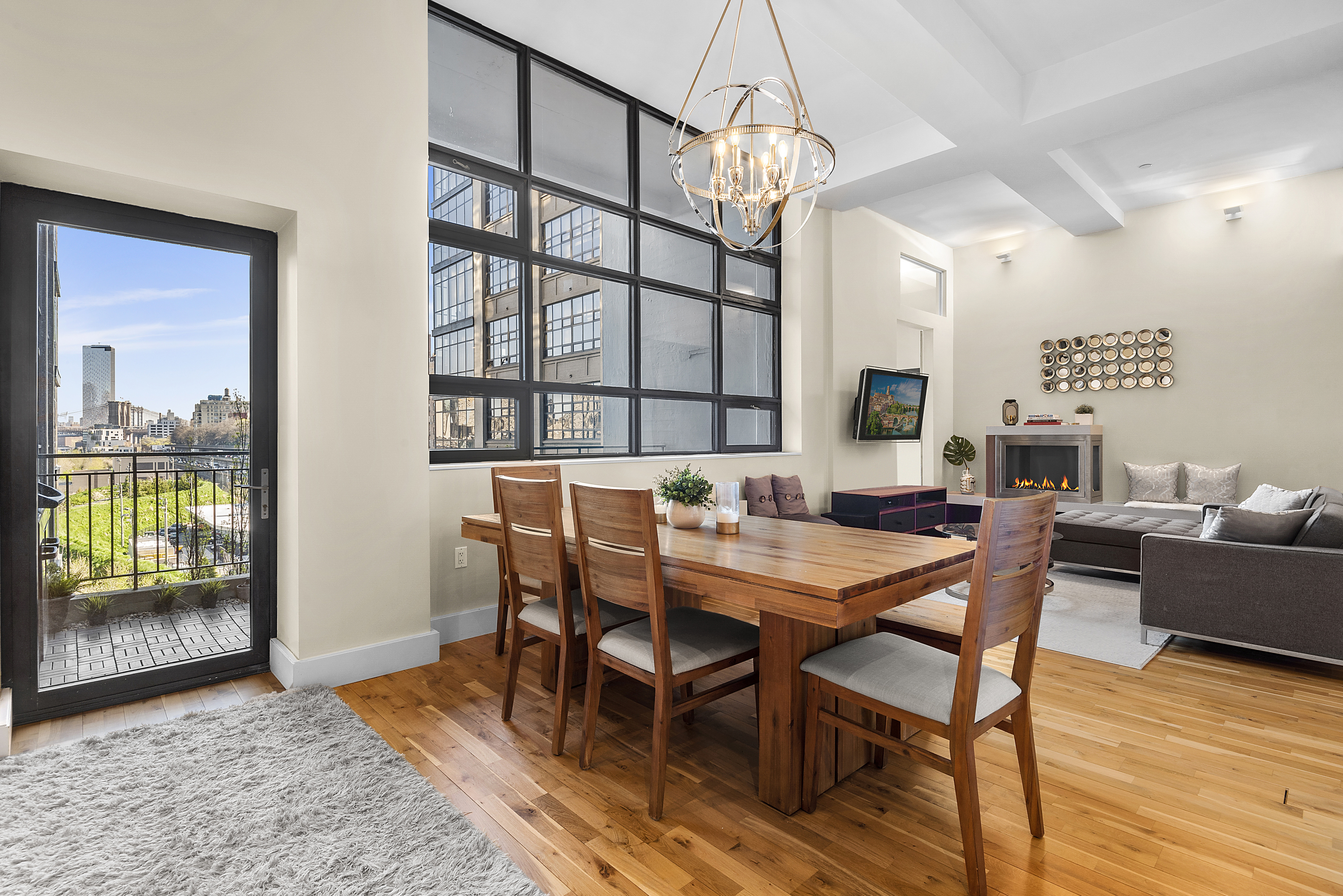 360 Furman Street, Unit 723/724 Brooklyn, NY 11201 - Photo 7 of 63 a view of a dining room with furniture wooden floor and chandelier