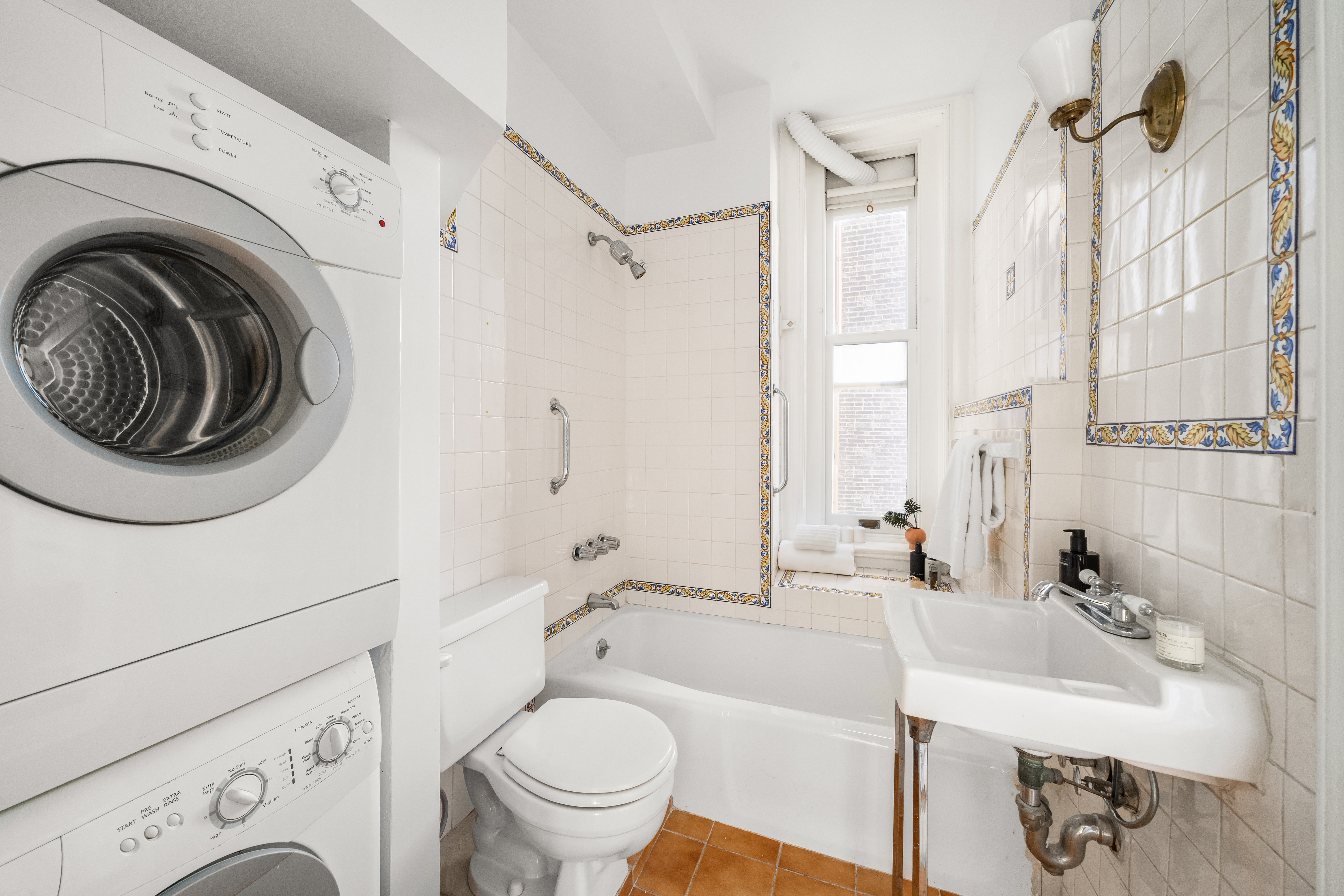 874 Broadway, Unit 907 Manhattan, NY 10003 - Photo 6 of 14 a bathroom with a sink a toilet and a bathtub