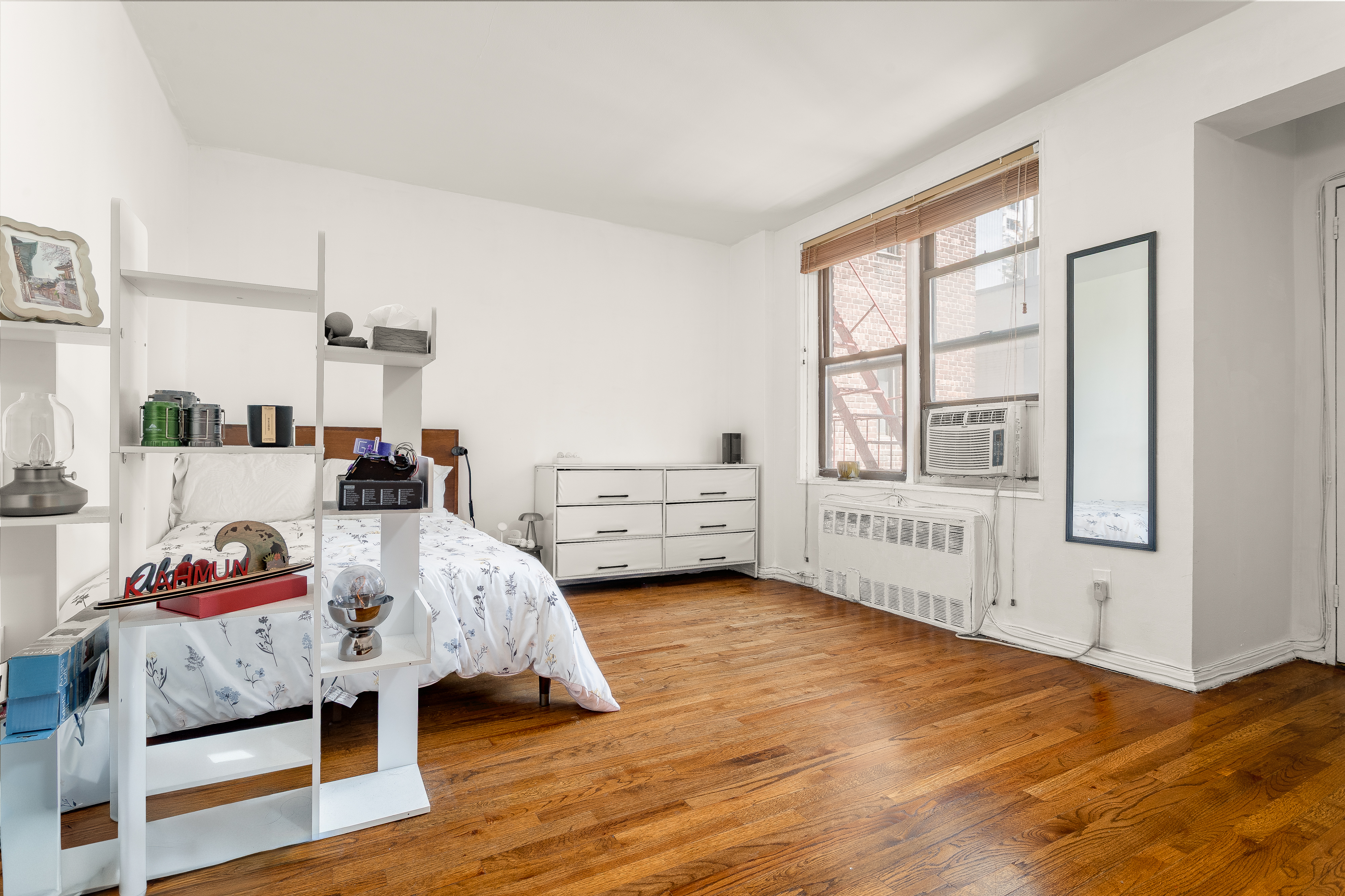 1420 York Avenue, Unit 6J Manhattan, NY 10021 - Photo 3 of 13 a bed room with a bed and a window