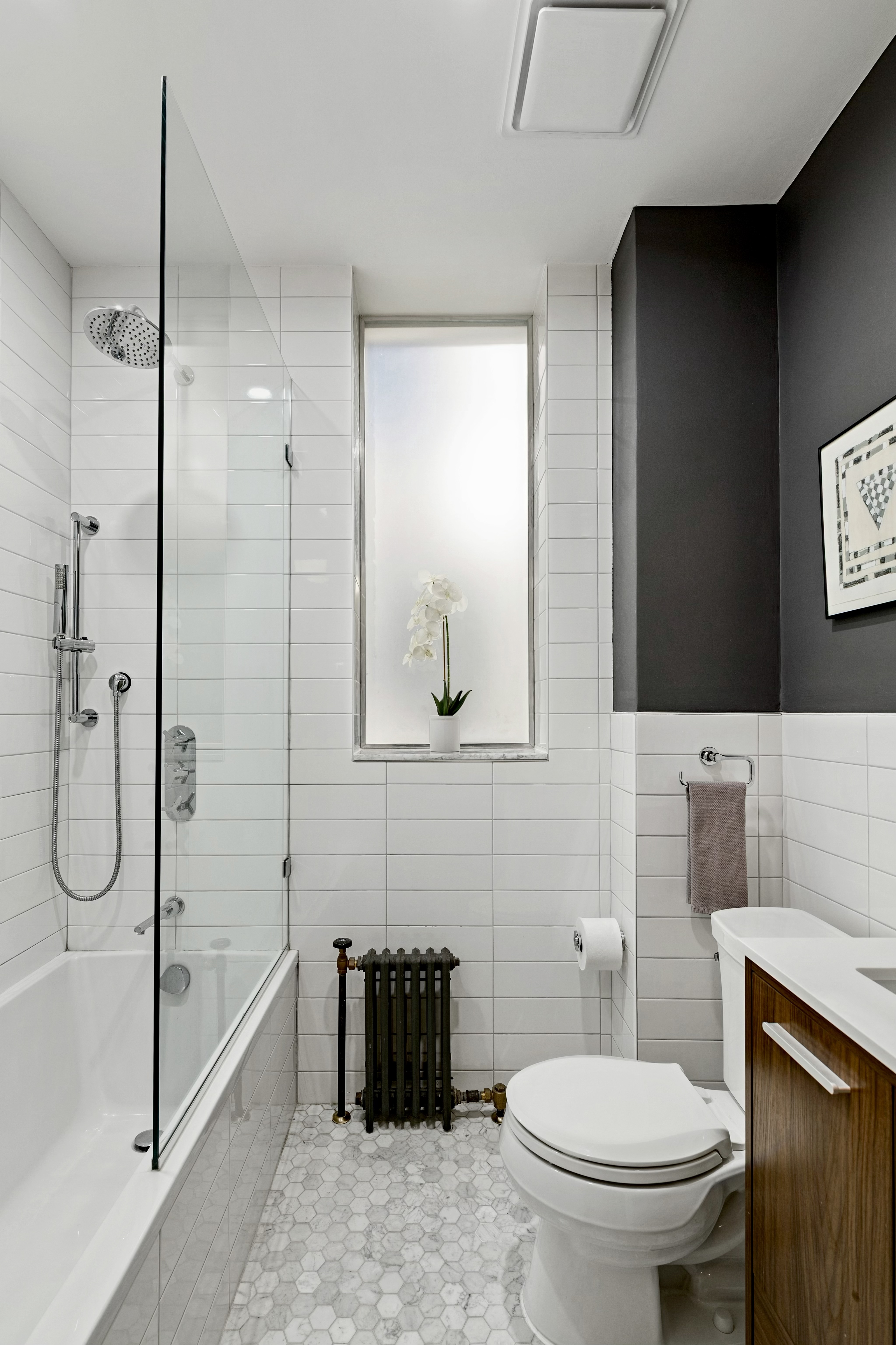 40 West 67th Street, Unit 1A Manhattan, NY 10023 - Photo 10 of 17 a bathroom with a toilet sink and shower