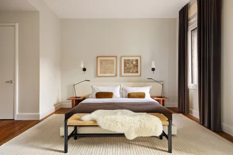 a bedroom with furniture and a window