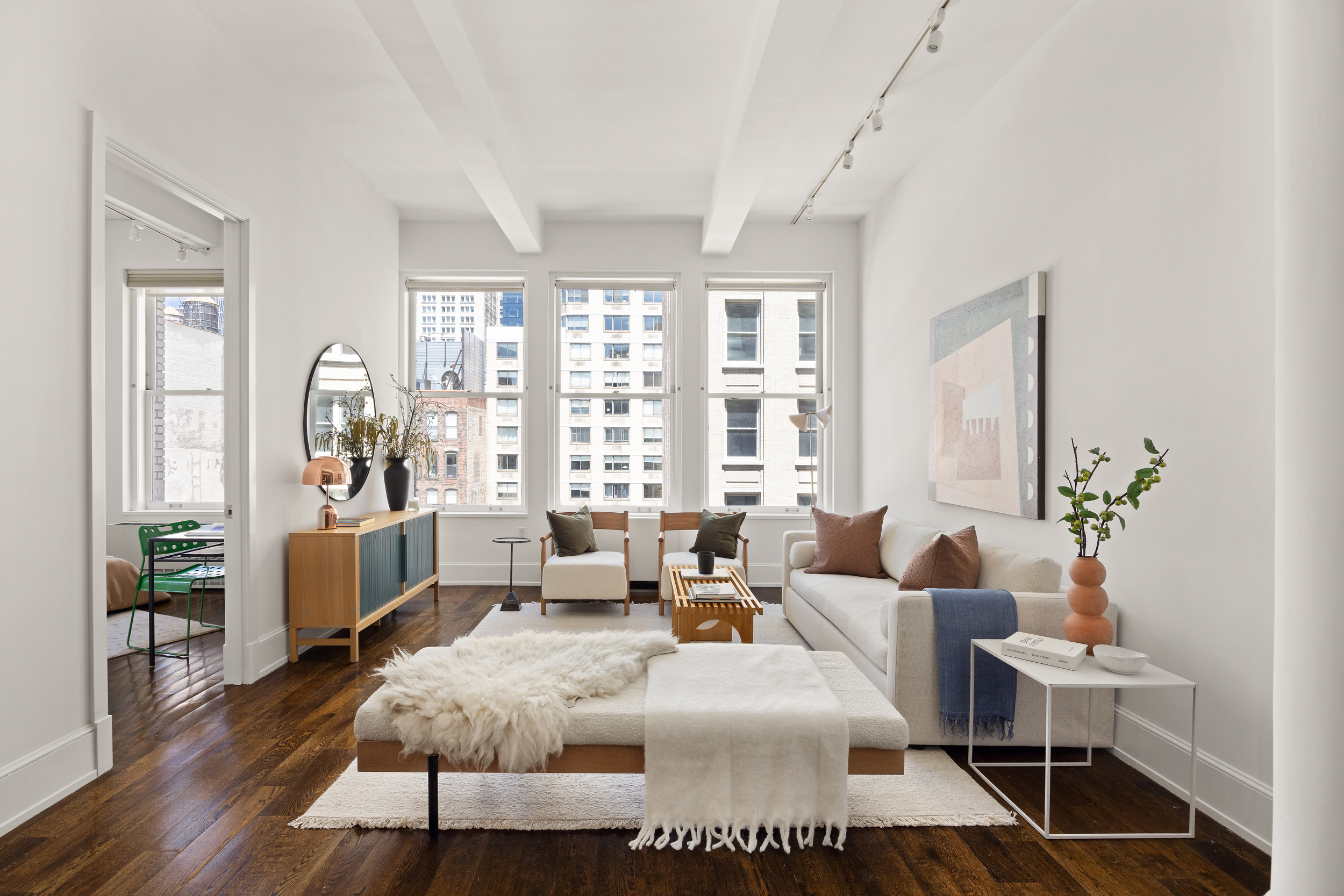 a living room with furniture and wooden floor
