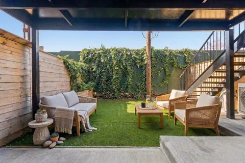 a view of yard from deck with patio