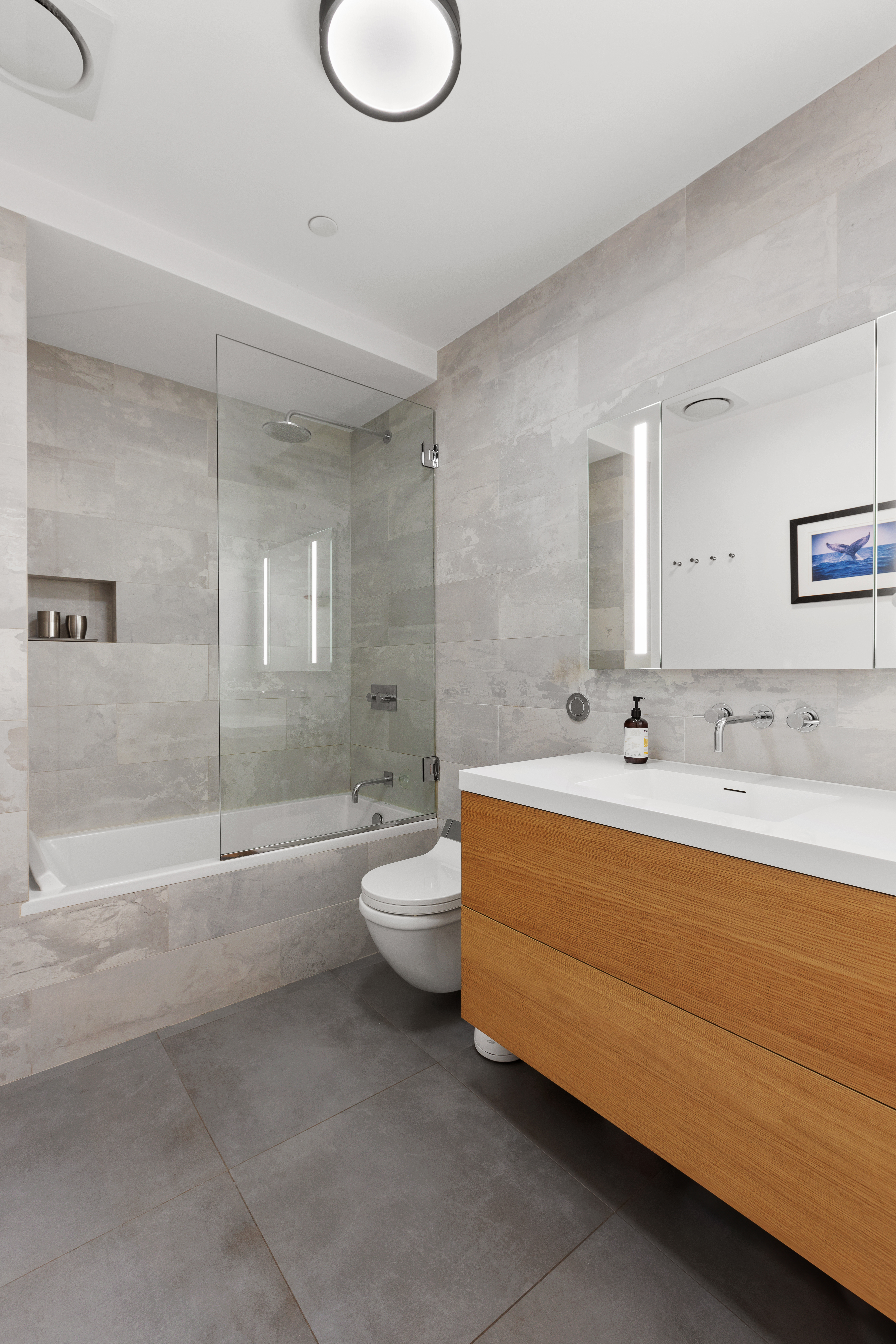 133-131 West 28th Street, Unit 7A Manhattan, NY 10001 - Photo 9 of 11 a bathroom with a sink a toilet and bathtub