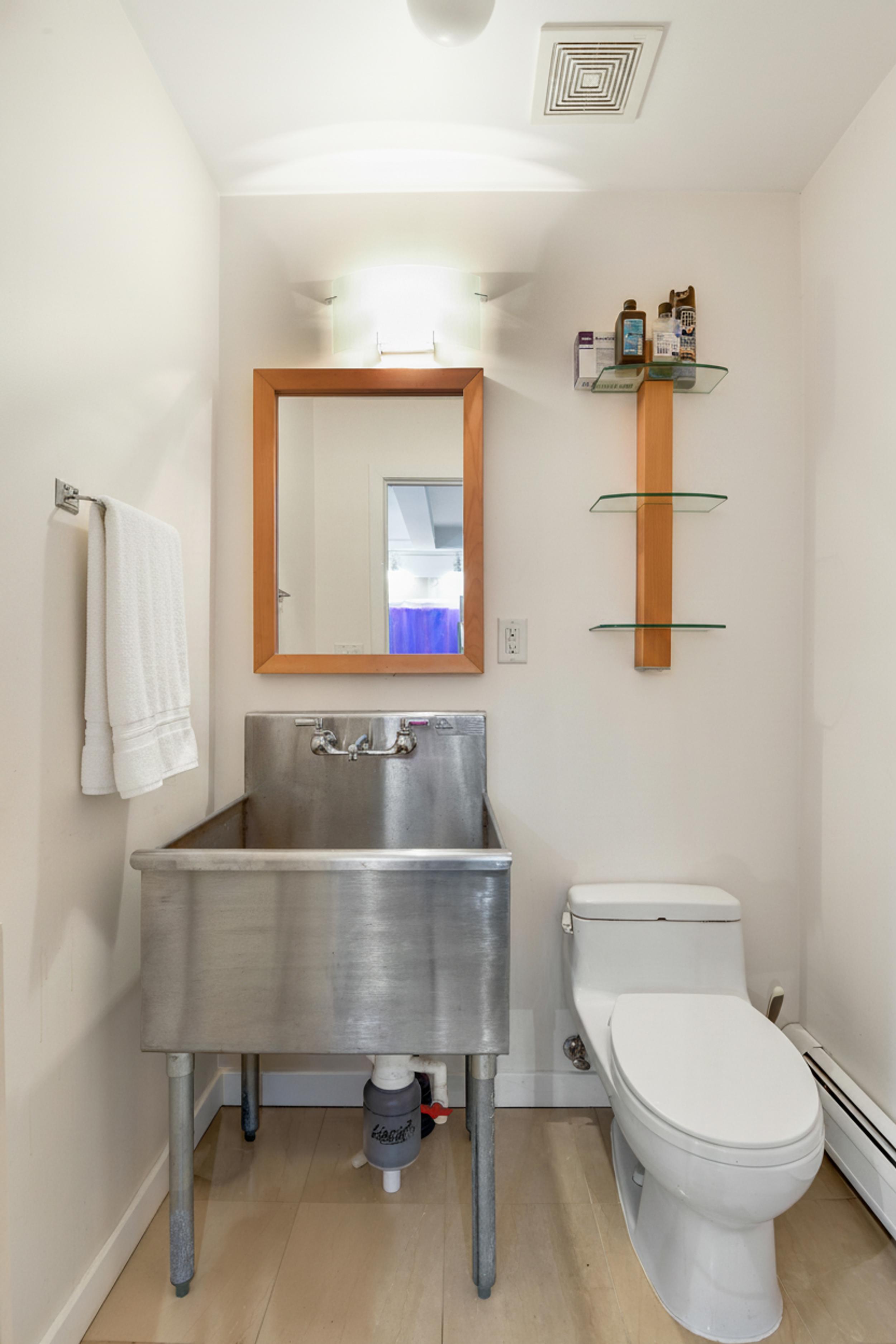 335 Warren Street, Unit 102 Brooklyn, NY 11201 - Photo 17 of 20 a bathroom with a sink and a toilet