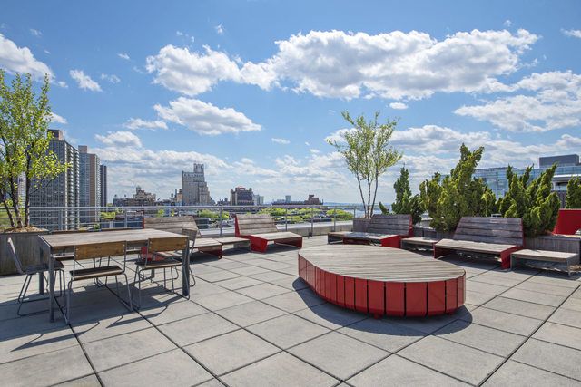 30 Main Street, Unit 10F Brooklyn, NY 11201 - Photo 15 of 16 a view of a swimming pool and lounge chairs