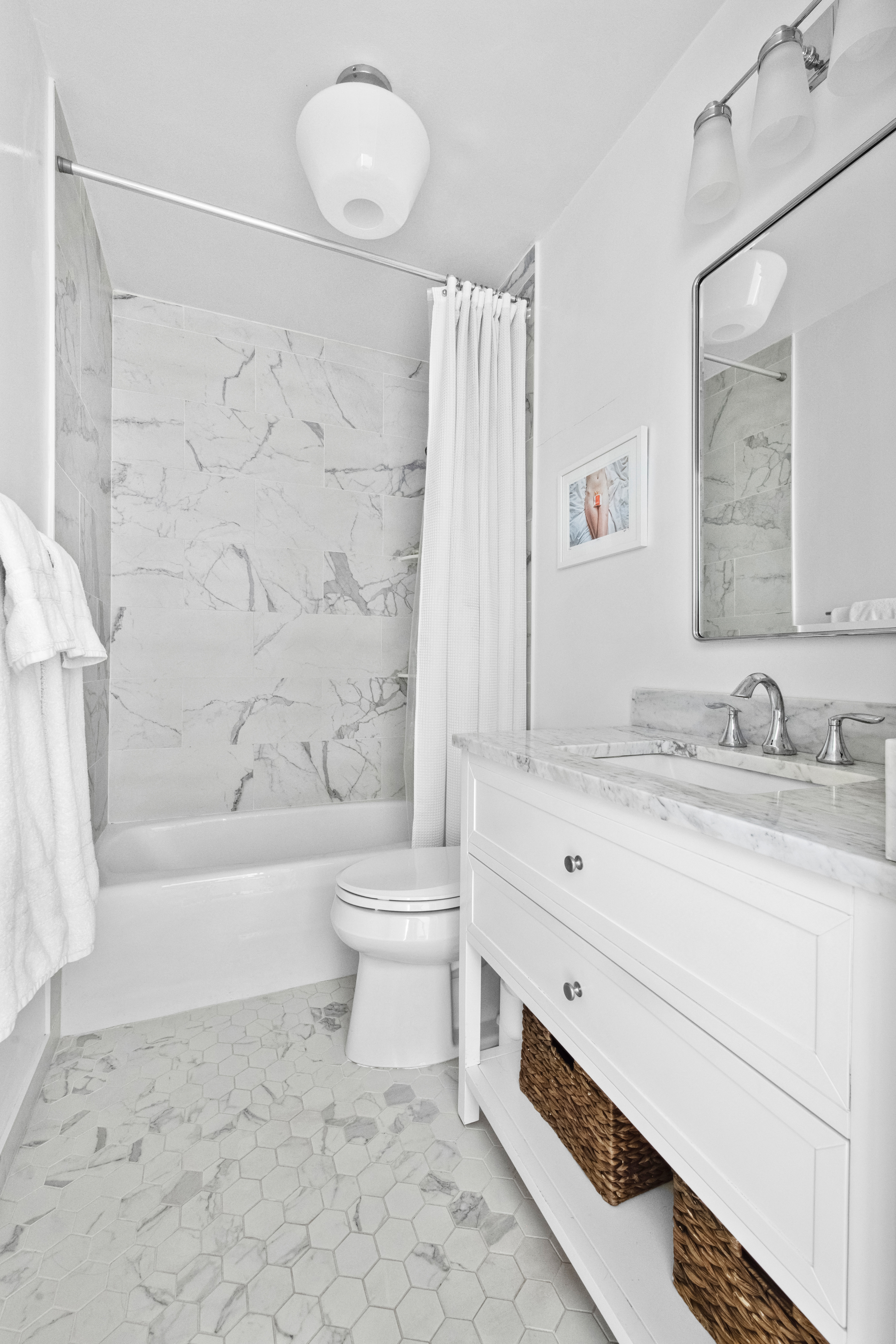 167 Perry Street, Unit 5H Manhattan, NY 10014 - Photo 6 of 8 a bathroom with a granite countertop toilet a sink and a bathtub