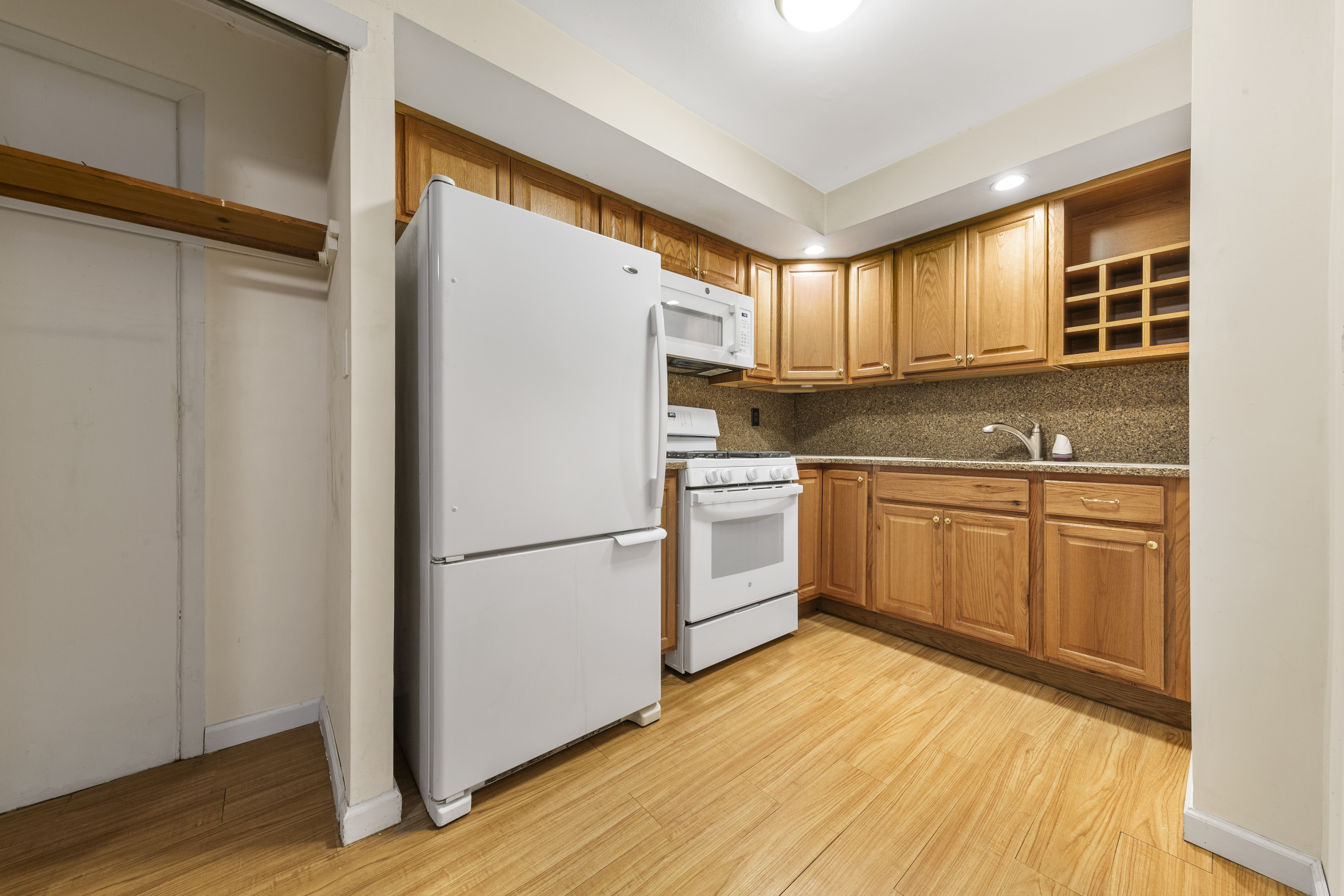 240-47 68th Avenue Queens, NY 11362 - Photo 27 of 39 a white refrigerator freezer sitting inside of a kitchen