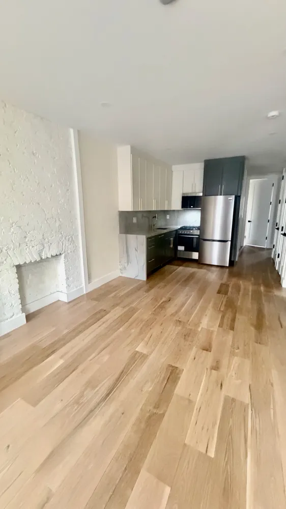 a large white kitchen with cabinets