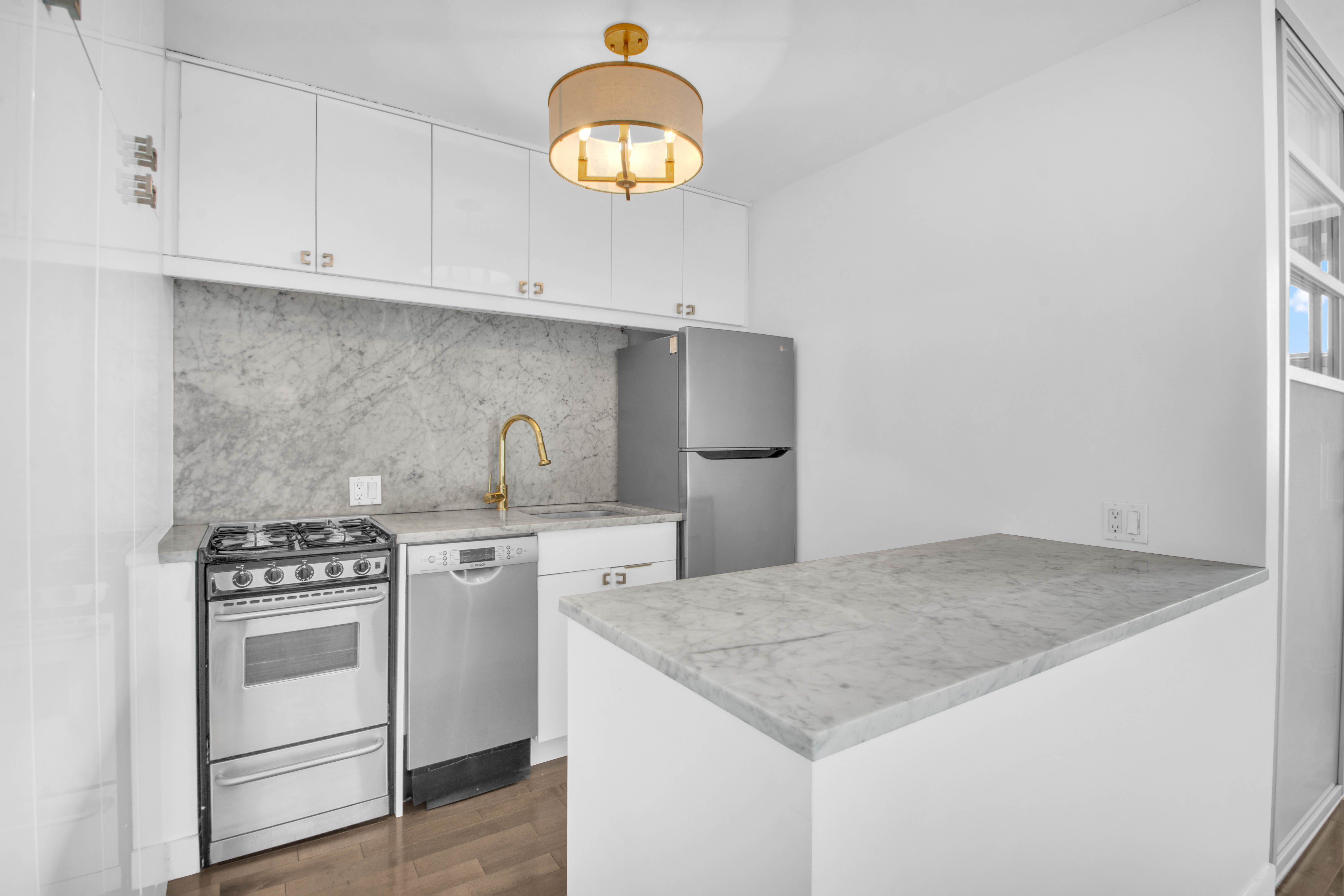 75 Henry Street, Unit 29J Brooklyn, NY 11201 - Photo 4 of 16 a kitchen with white cabinets and appliances