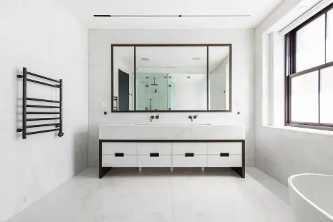 a bathroom with a double vanity sink mirror and a bathtub