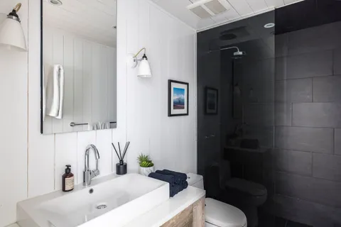 a bathroom with a sink toilet and shower