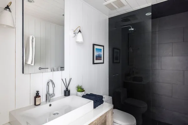a bathroom with a sink toilet and shower