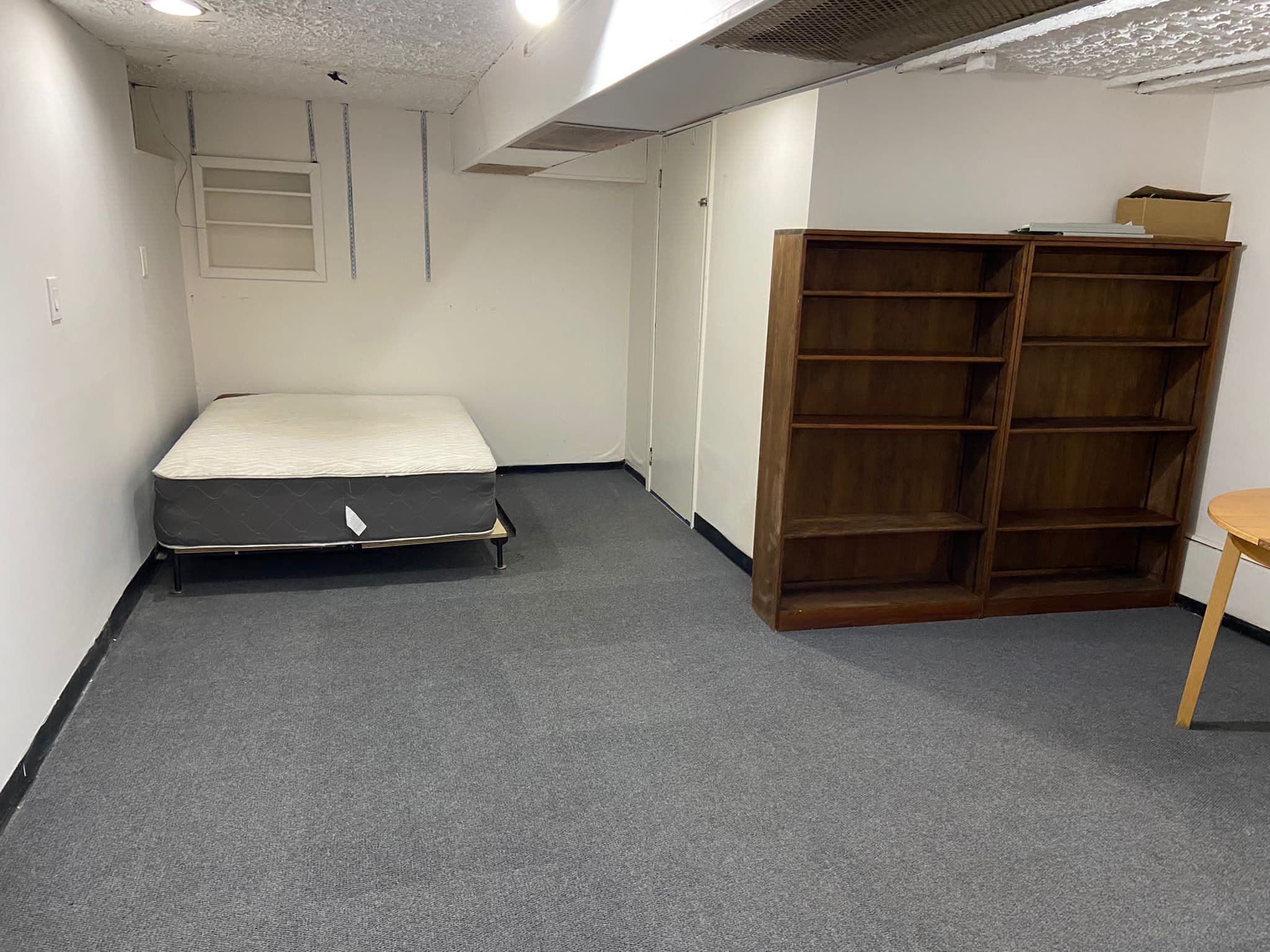 1065 East 39th Street Brooklyn, NY 11210 - Photo 12 of 15 a spacious bedroom with a bed and a cabinets