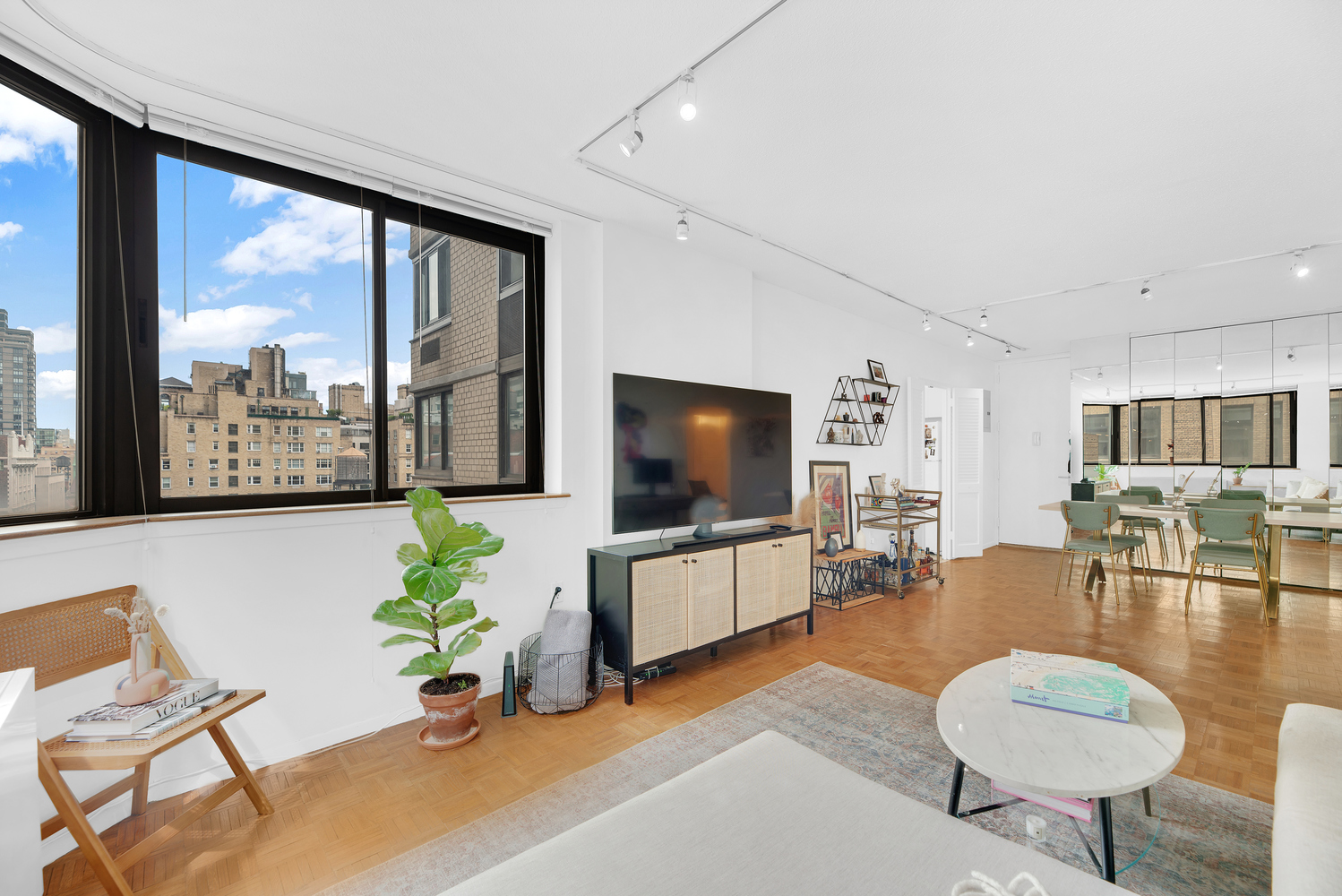 280 Park Avenue South, Unit 13M Manhattan, NY 10010 - Photo 2 of 15 a living room with furniture and a flat screen tv