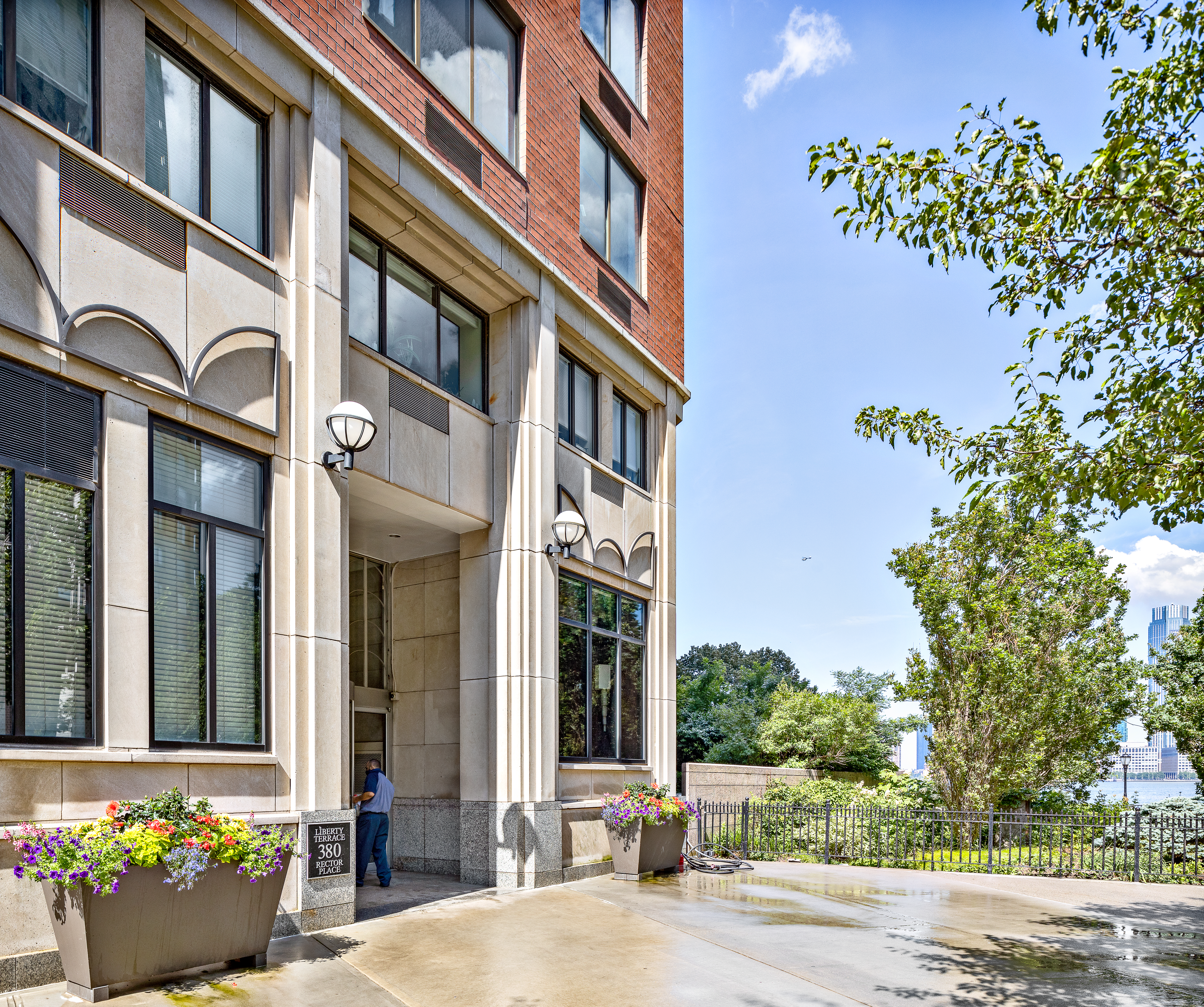 380 Rector Place, Unit 7LMN Manhattan, NY 10280 - Photo 13 of 14 a front view of a building with potted plants