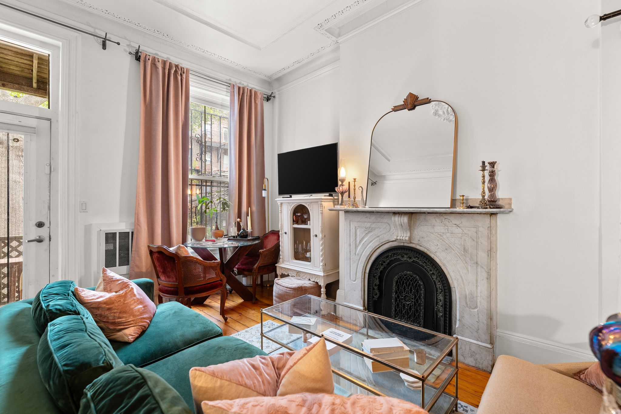 a living room with furniture a fireplace and a flat screen tv
