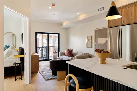a kitchen with a sink appliances and a dining table view