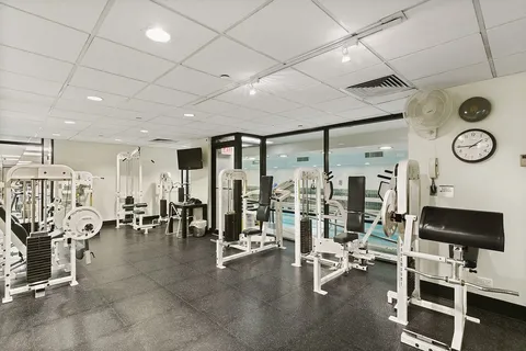 a view of a room with gym equipment and a large window