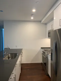 a kitchen with a refrigerator and a sink