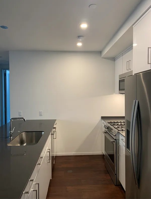 a kitchen with a refrigerator and a sink