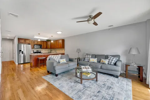 a living room with furniture and kitchen view