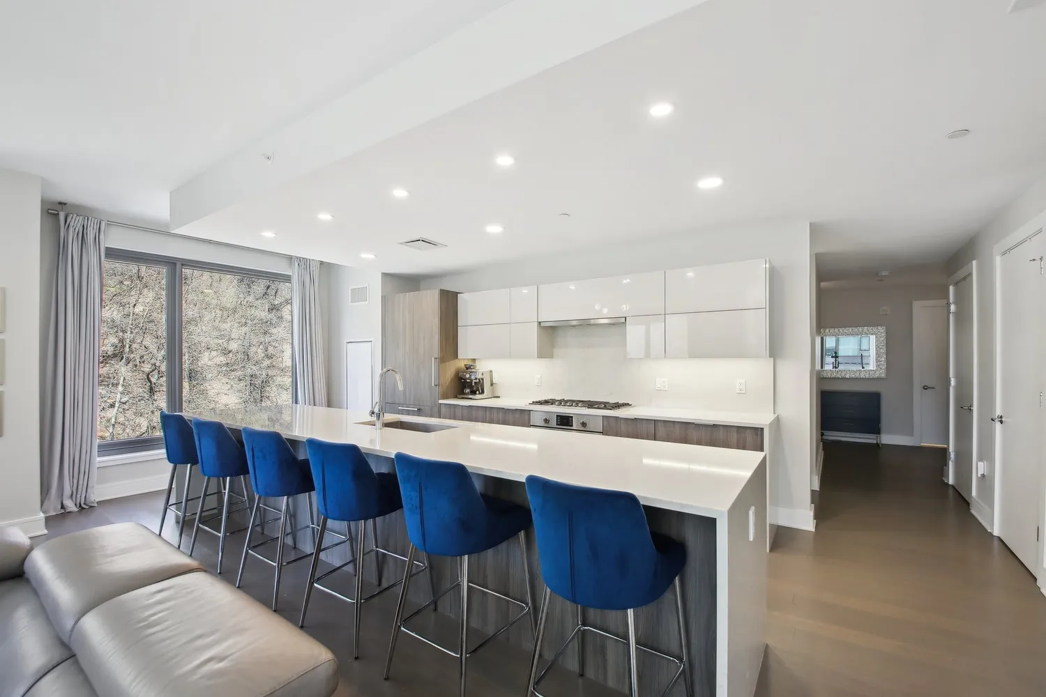 a large kitchen with a table and chairs
