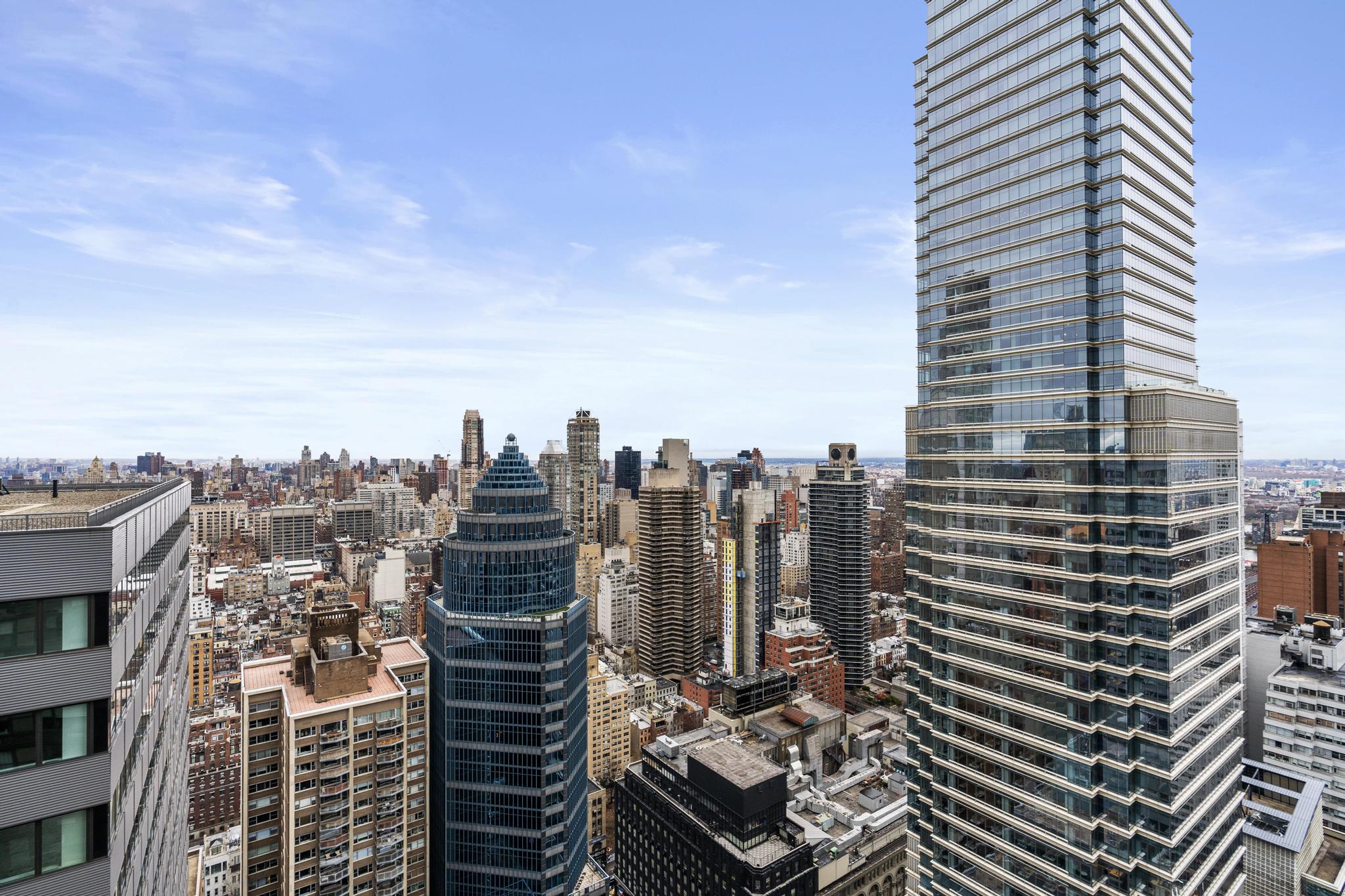 117 East 57th Street, Unit 48G Manhattan, NY 10022 - Photo 7 of 13 a view of a city with tall buildings