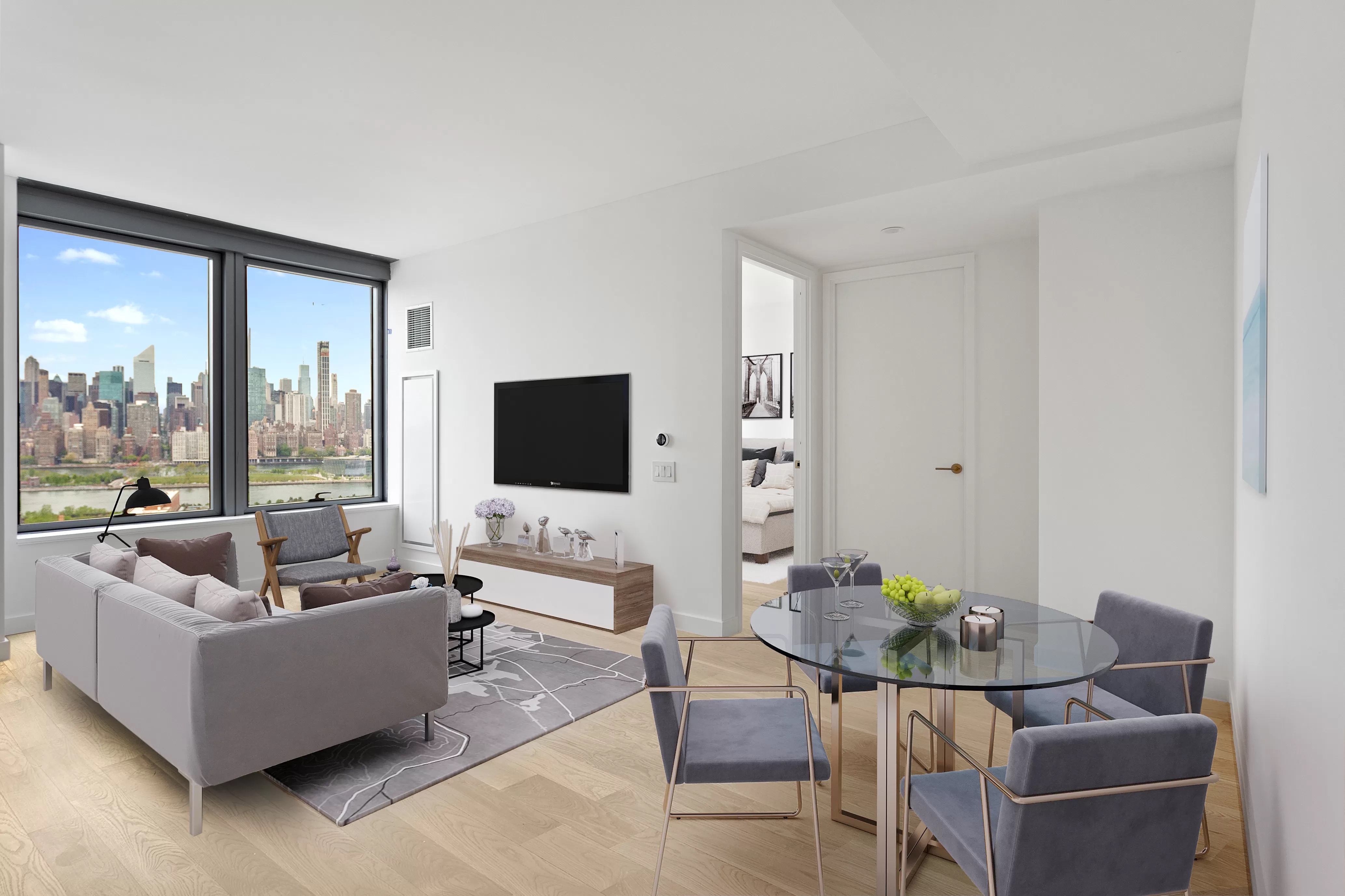 3 Court Square, Unit 3212 Queens, NY 11101 - Photo 3 of 14 a living room with furniture and a flat screen tv