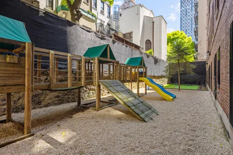 a view of a house with backyard and wooden fence