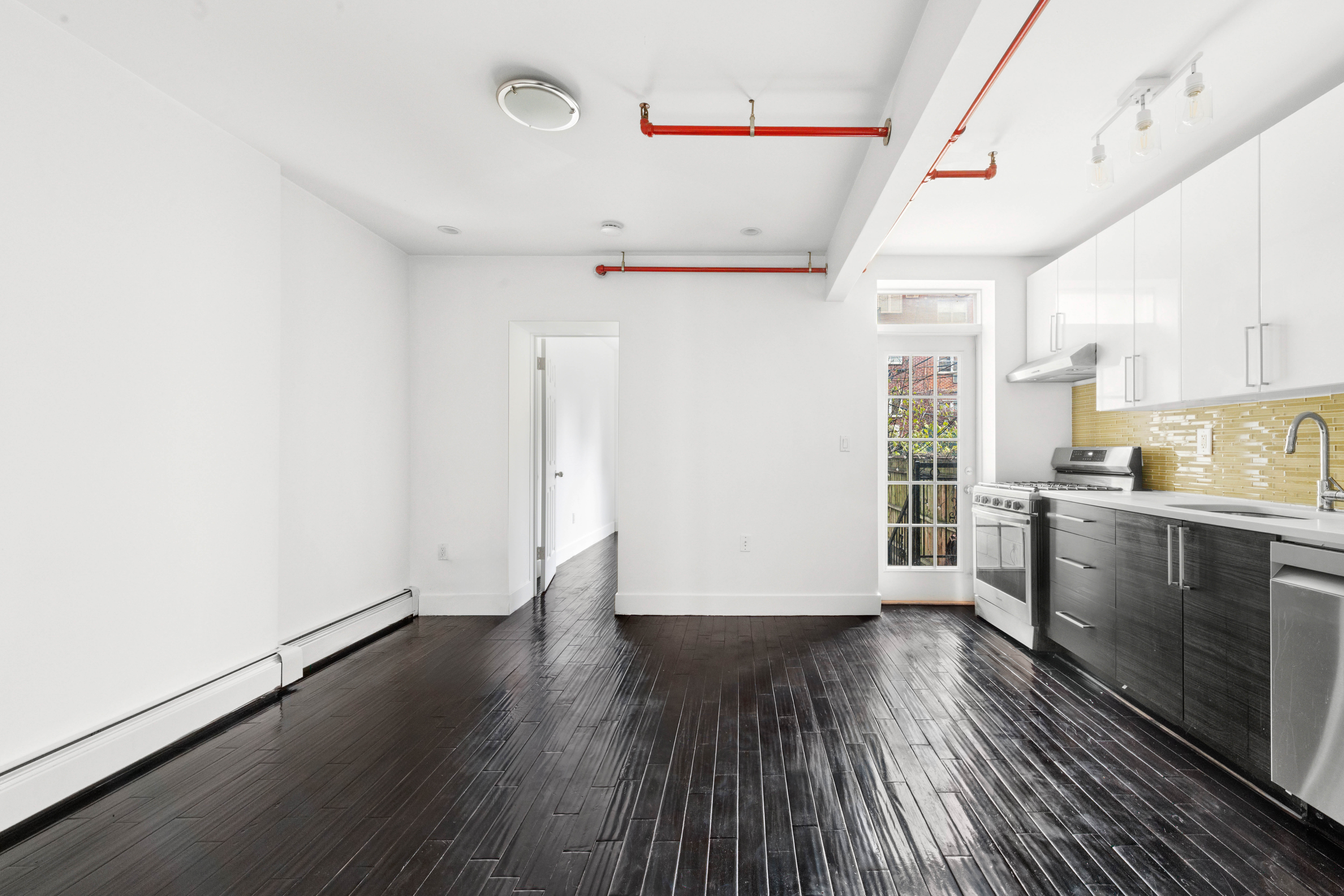 155 A 9th Street, Unit 1 Brooklyn, NY 11231 - Photo 3 of 15 a view of a kitchen with wooden floor and electronic appliances