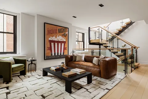 a living room with furniture a rug and a window