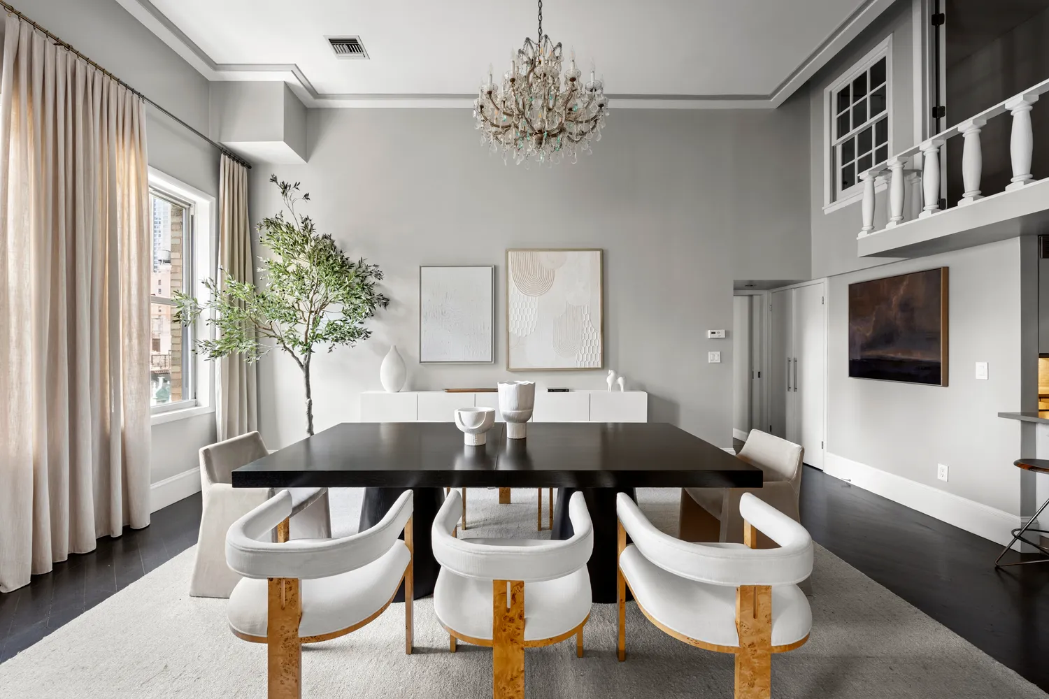a view of a dining room with furniture and a chandelier