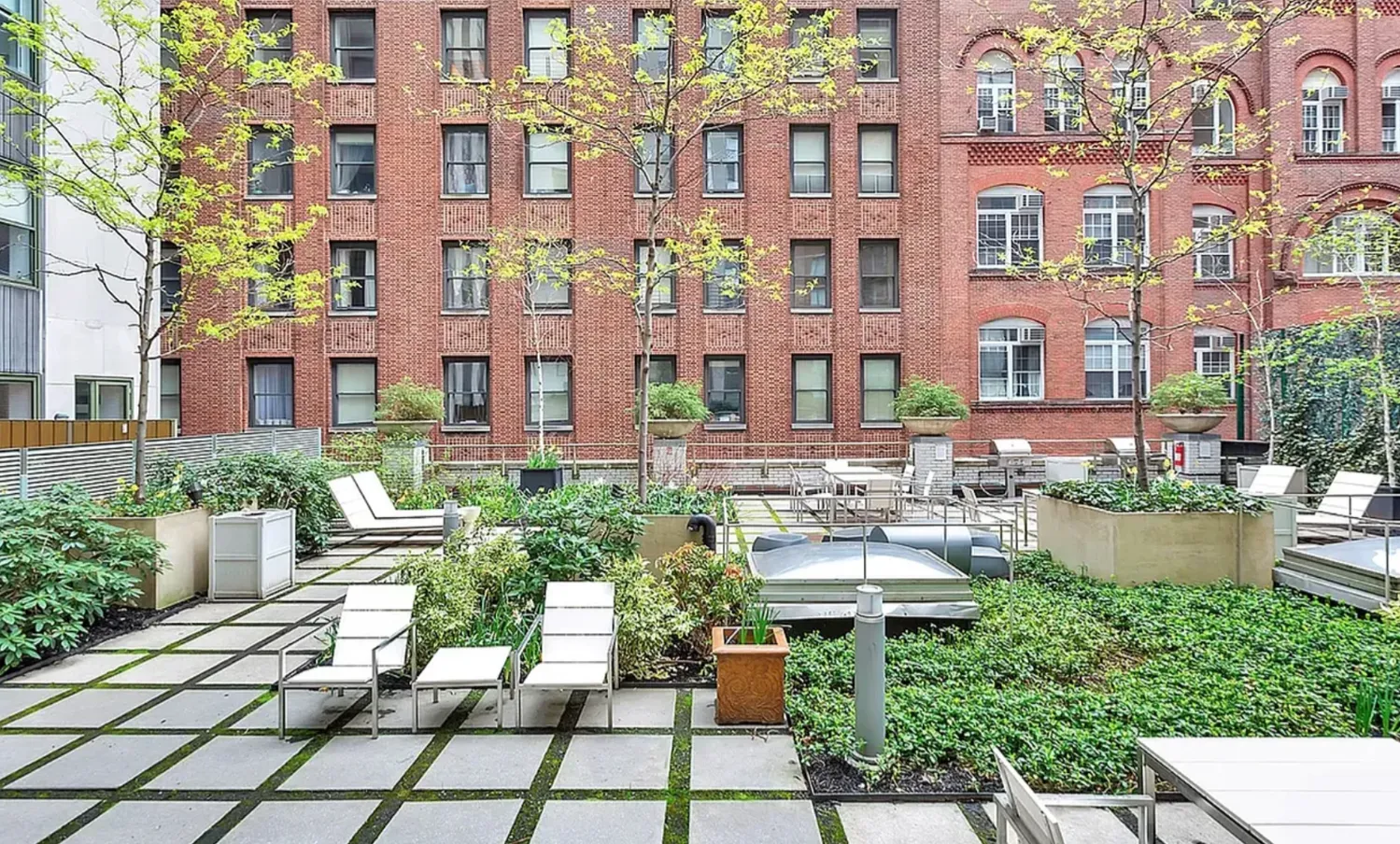 a view of a patio with couches table and chairs and potted plants