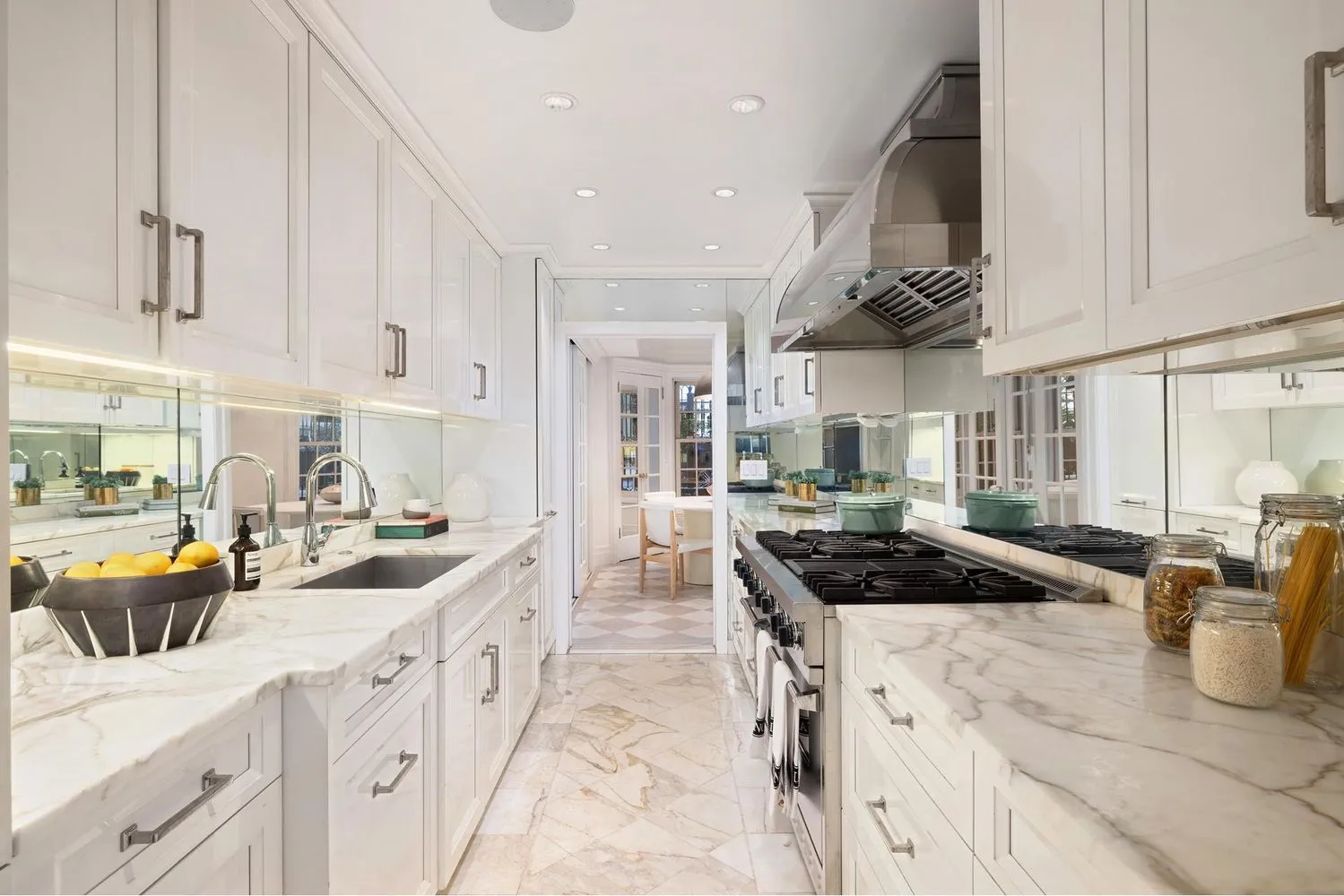 a kitchen with stainless steel appliances a stove a sink a refrigerator and cabinets