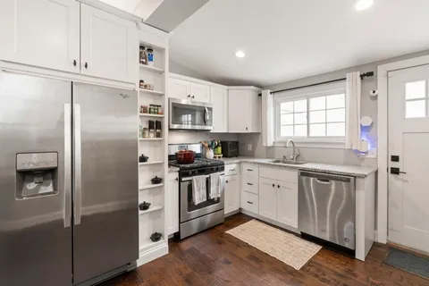 a kitchen with stainless steel appliances a refrigerator sink and microwave