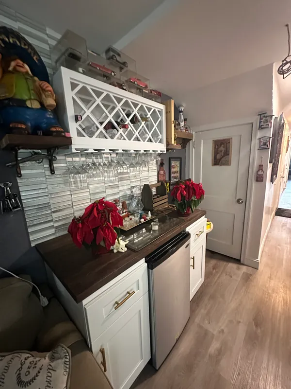 a kitchen with a stove and a wooden floor