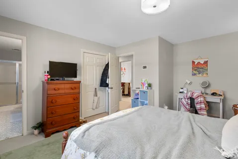 a bedroom with a bed and a flat tv screen