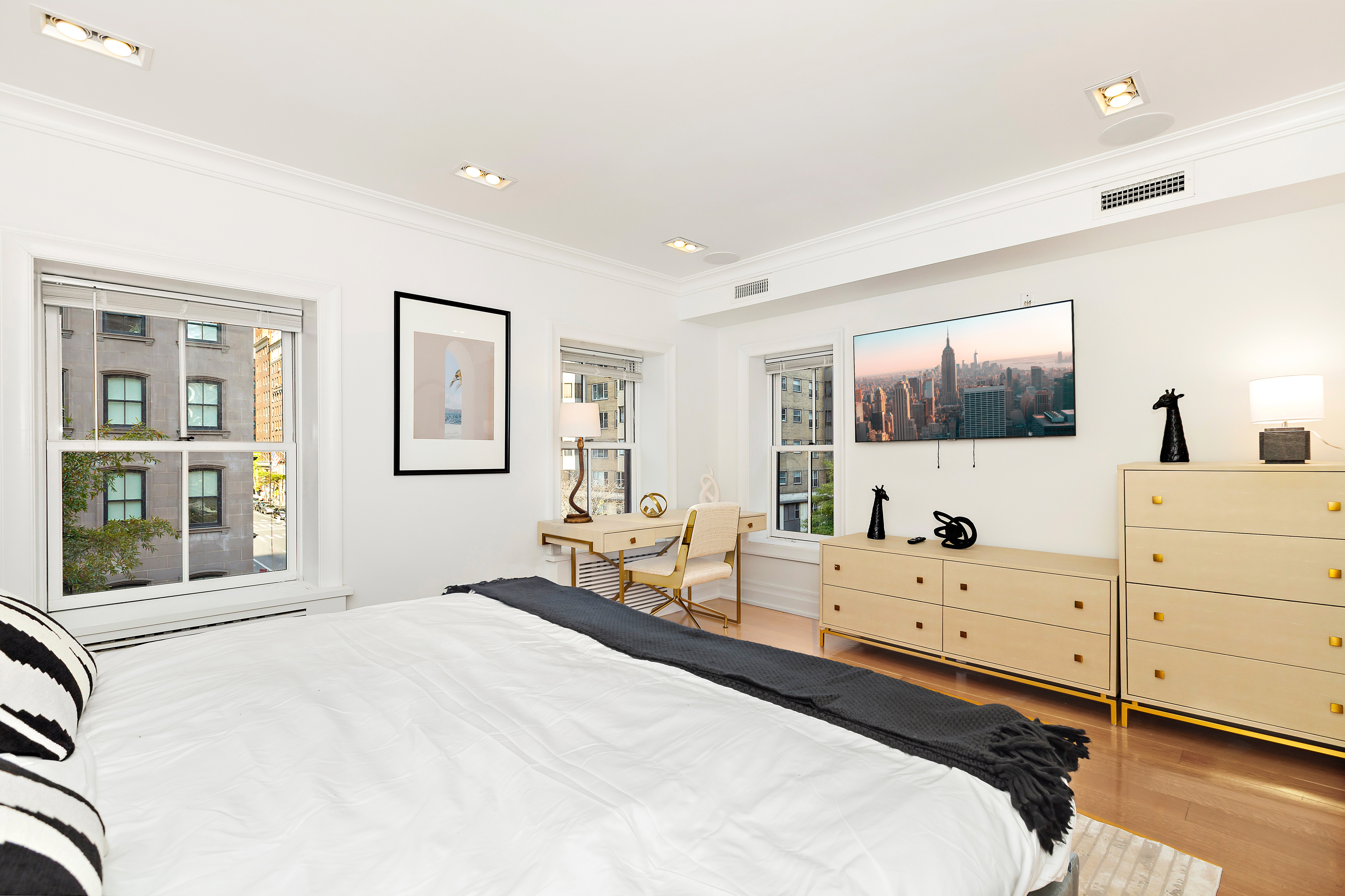 134 East 36th Street Manhattan, NY 10016 - Photo 12 of 28 a bedroom with a bed and large windows