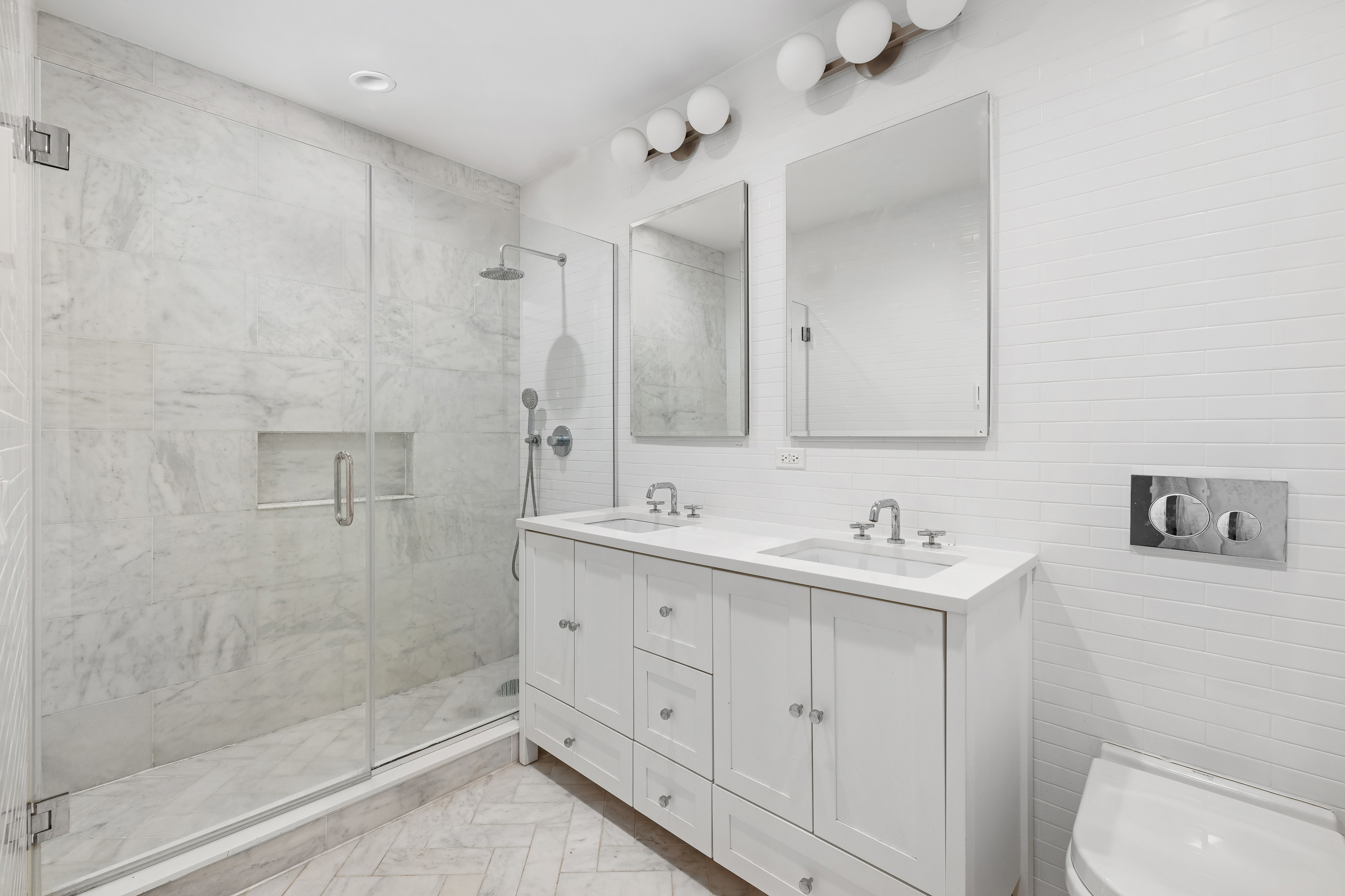 49 East 4th Street Brooklyn, NY 11218 - Photo 9 of 16 a bathroom with a double vanity sink toilet and shower