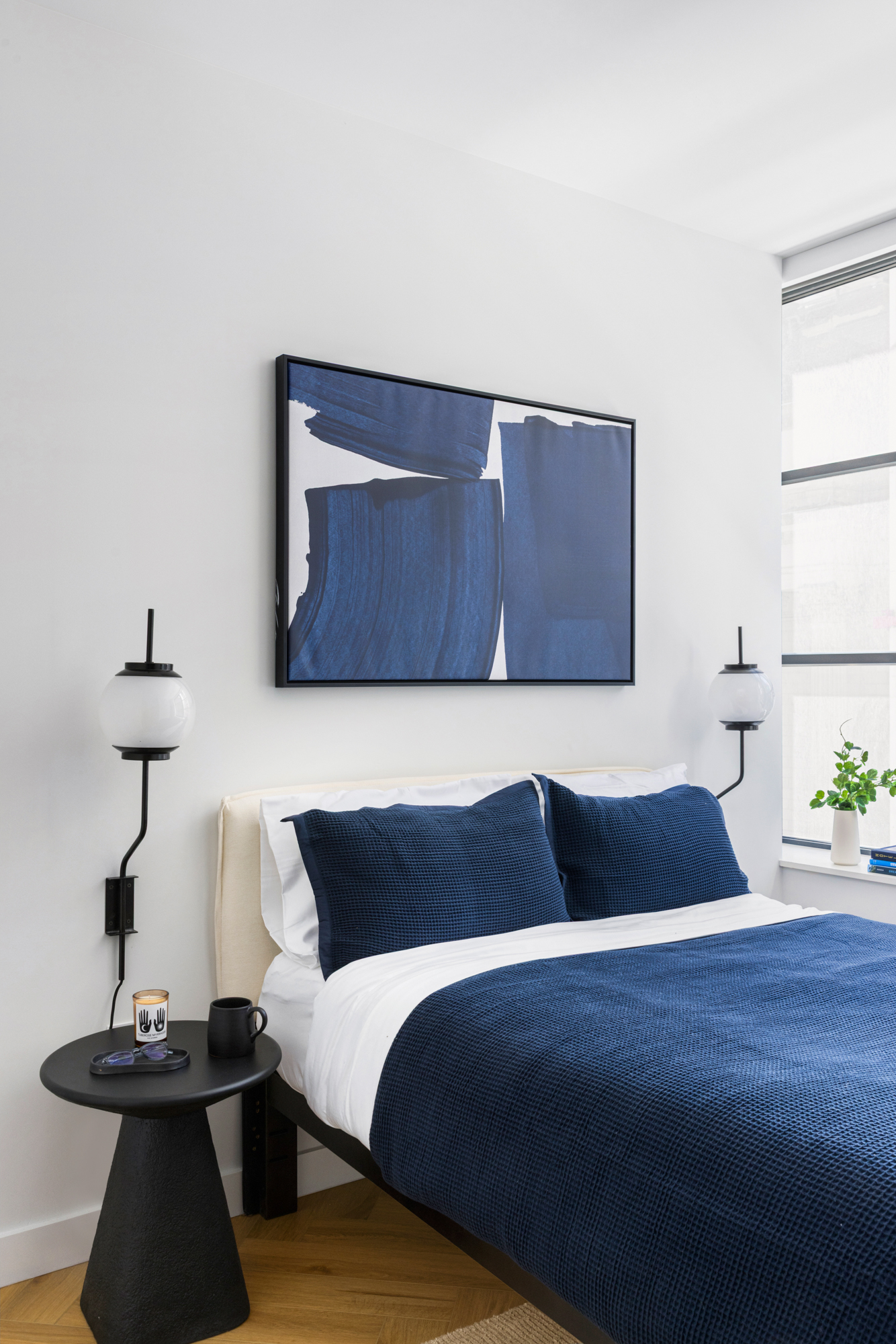 980 6th Avenue, Unit 301 Manhattan, NY 10018 - Photo 3 of 12 a bedroom with a bed and a potted plant