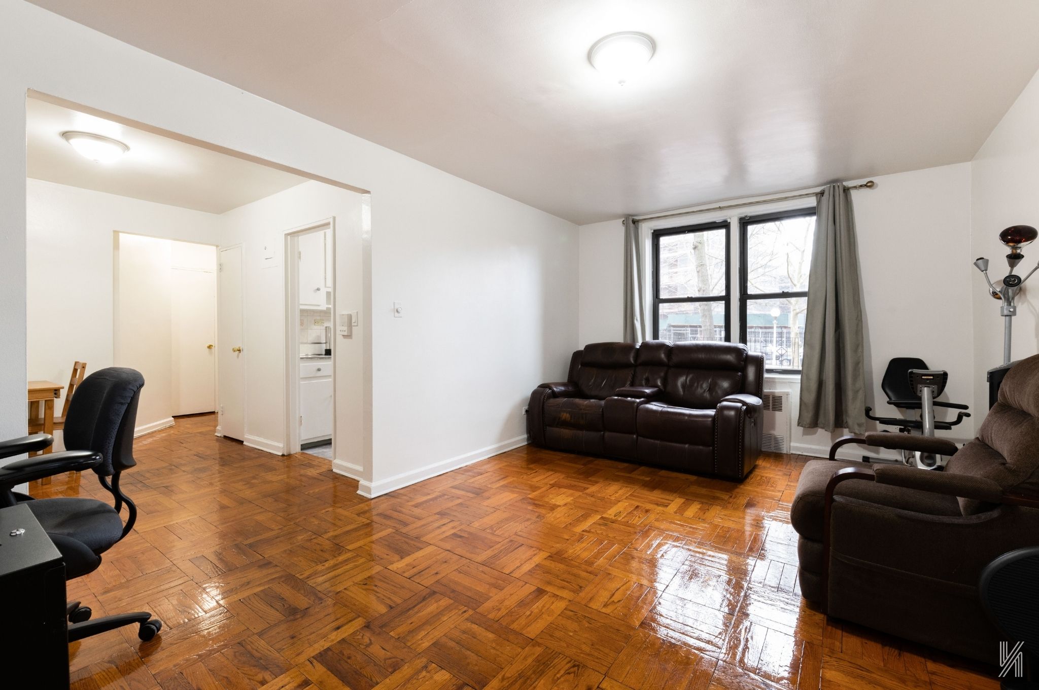33-24 Junction Boulevard, Unit 1R Queens, NY 11372 - Photo 5 of 17 a living room with furniture and a flat screen tv