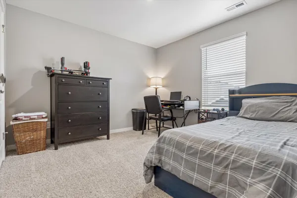 a bedroom with a bed and a dresser