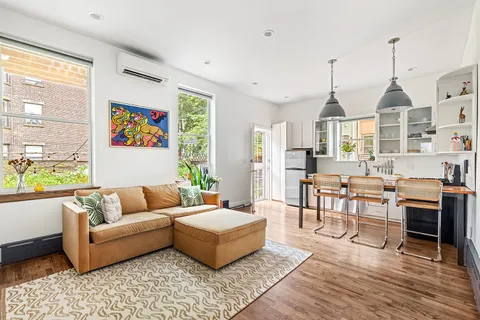 a living room with furniture fireplace and a window