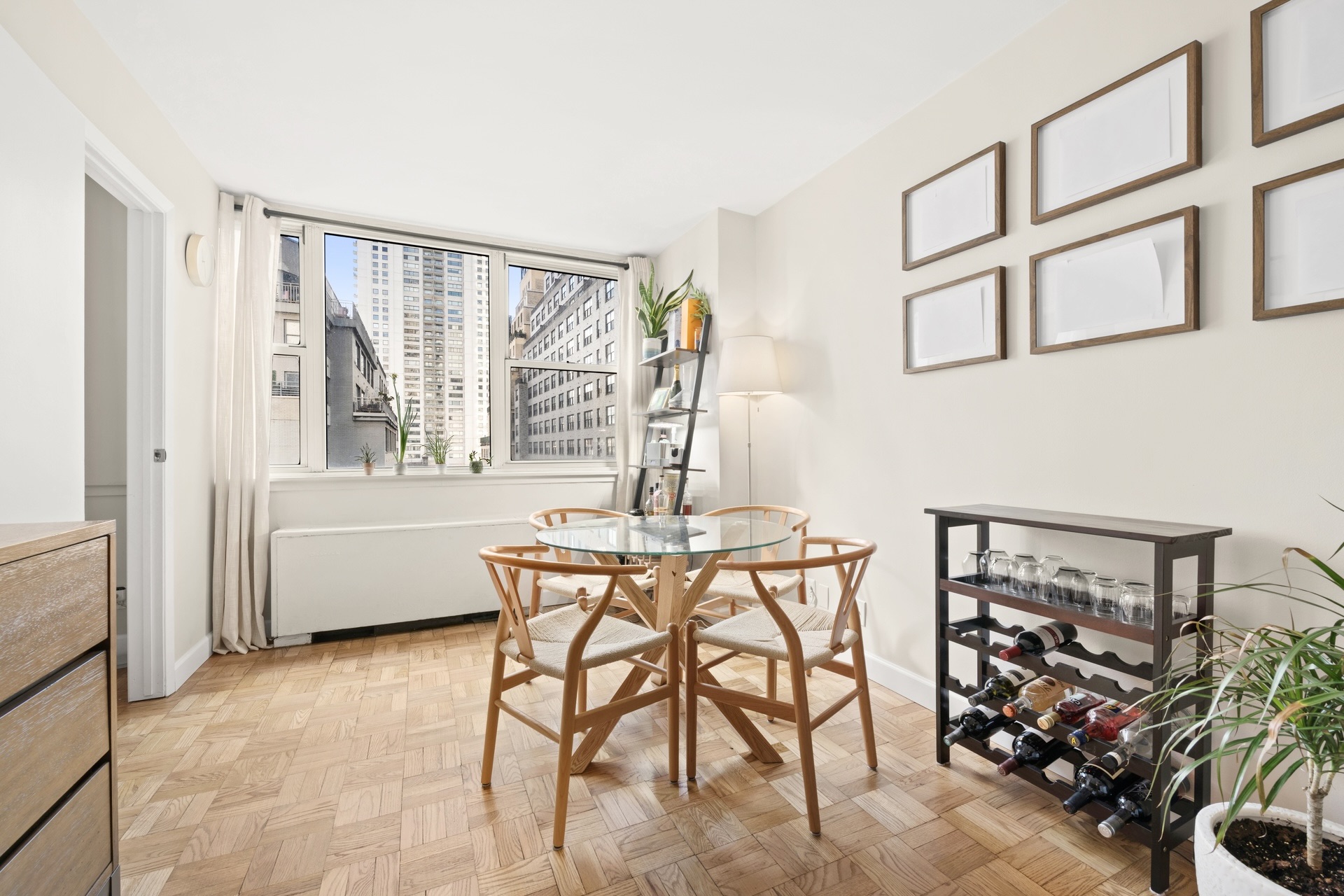 200 East 58th Street, Unit 10J Manhattan, NY 10022 - Photo 2 of 8 a dining room with furniture and window