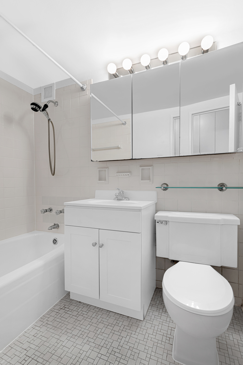 330 East 49th Street, Unit 3E Manhattan, NY 10017 - Photo 4 of 5 a bathroom with a sink a toilet and bathtub
