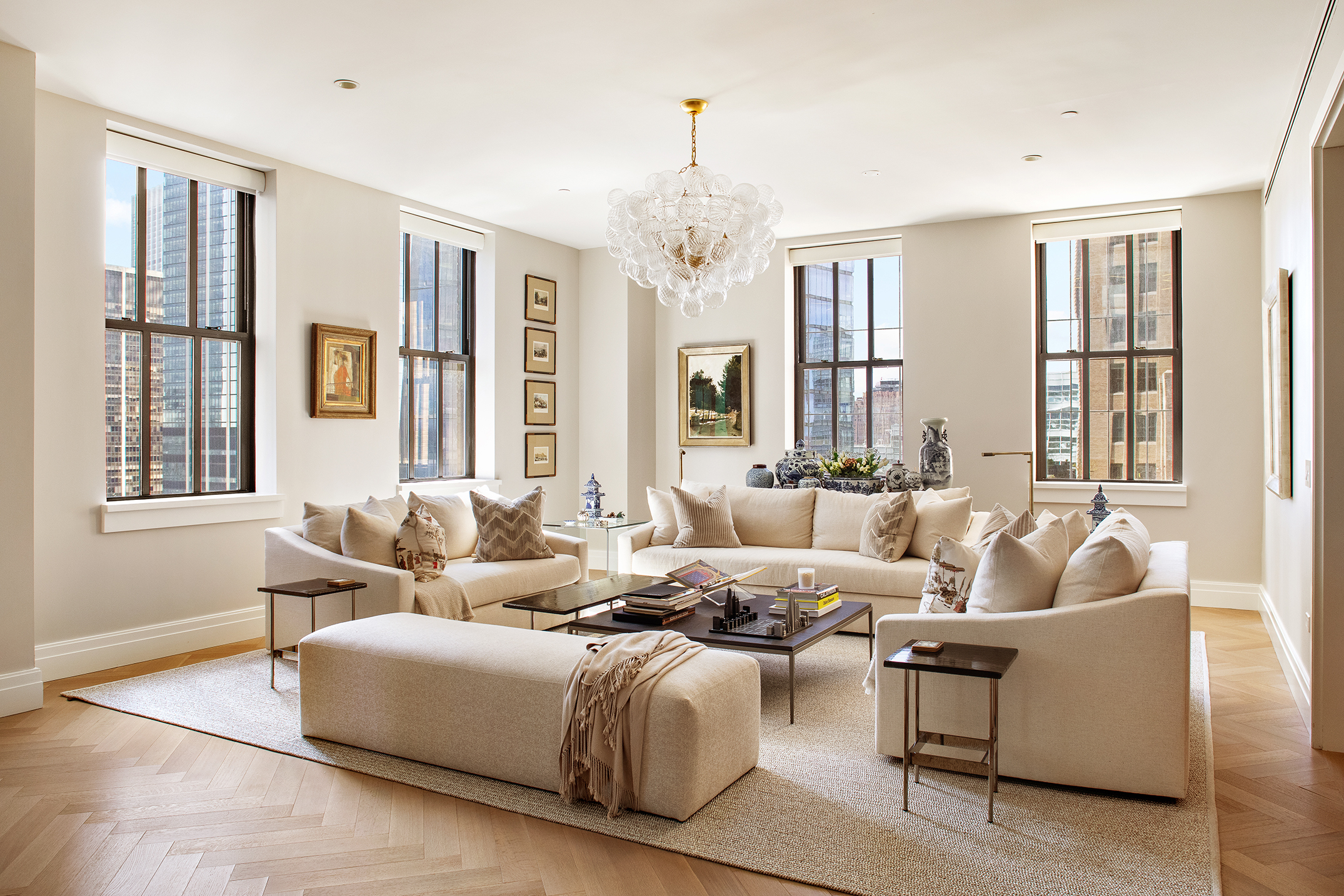 a living room with furniture and a chandelier