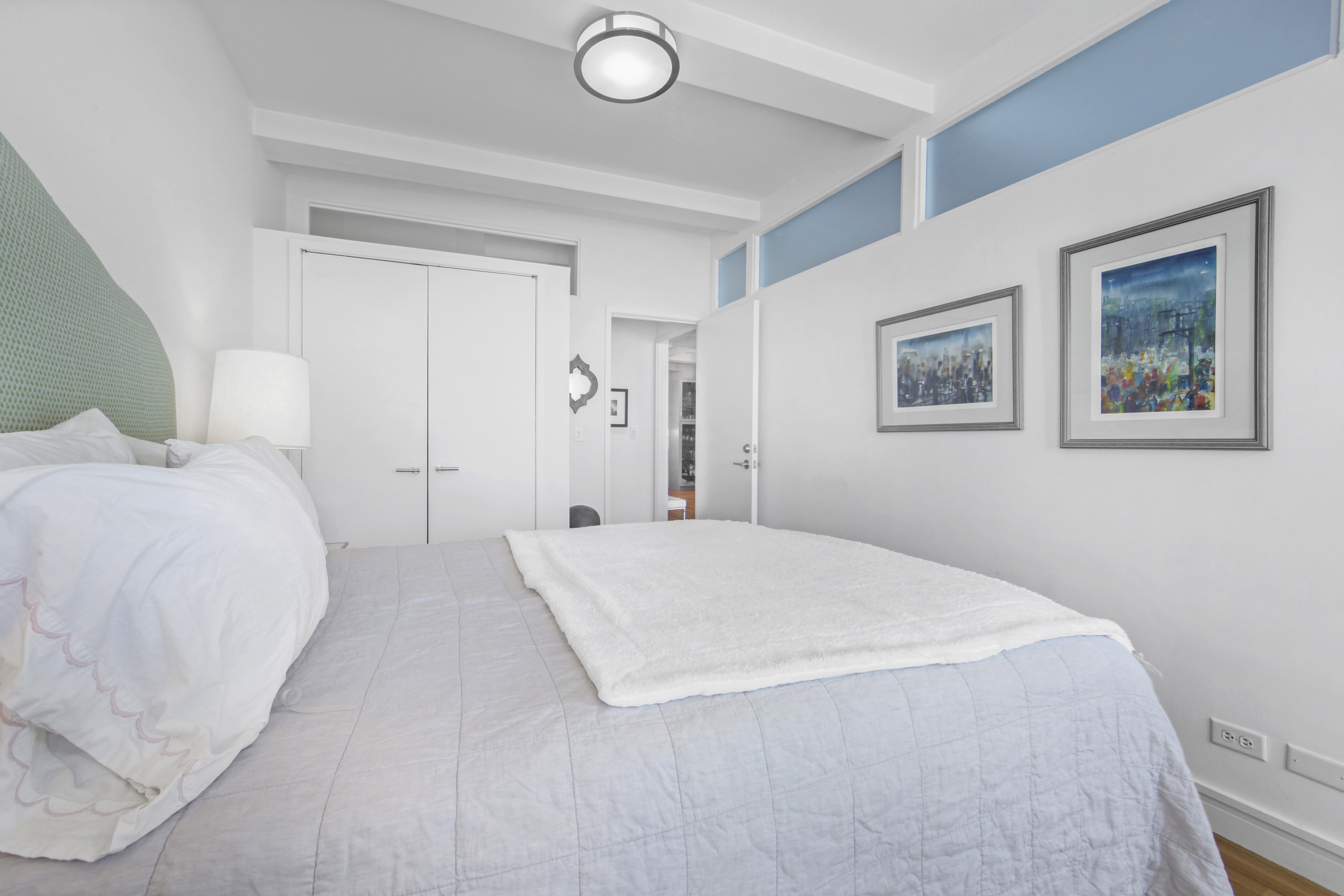 18 East 12th Street, Unit 7BC Manhattan, NY 10003 - Photo 17 of 26 a bedroom with a bed and a painting on the wall