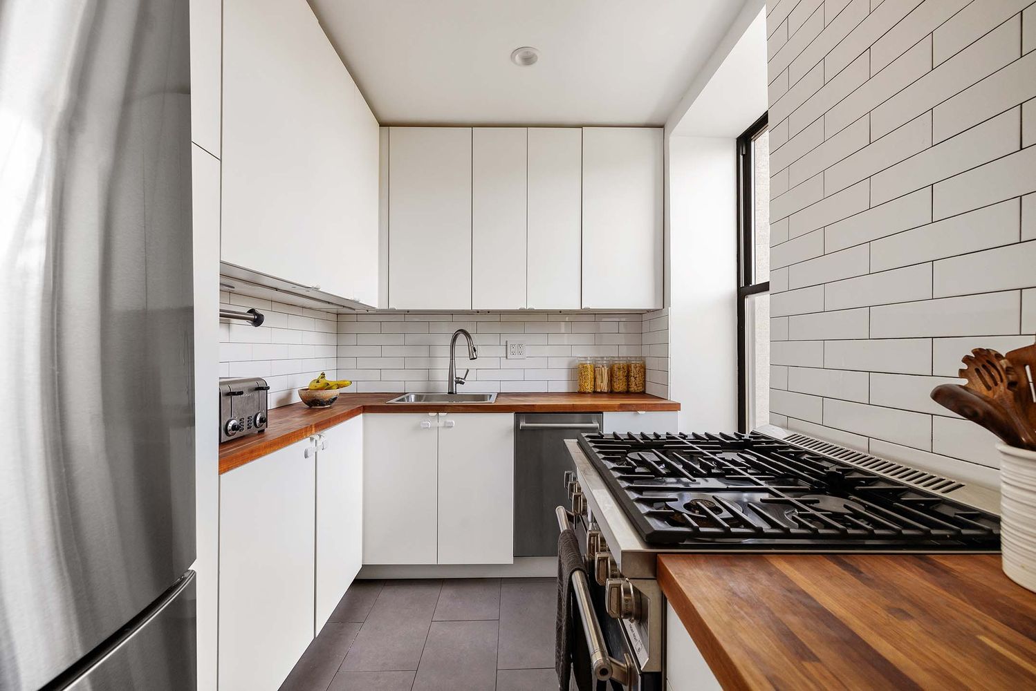 a kitchen with stainless steel appliances granite countertop a stove and a refrigerator