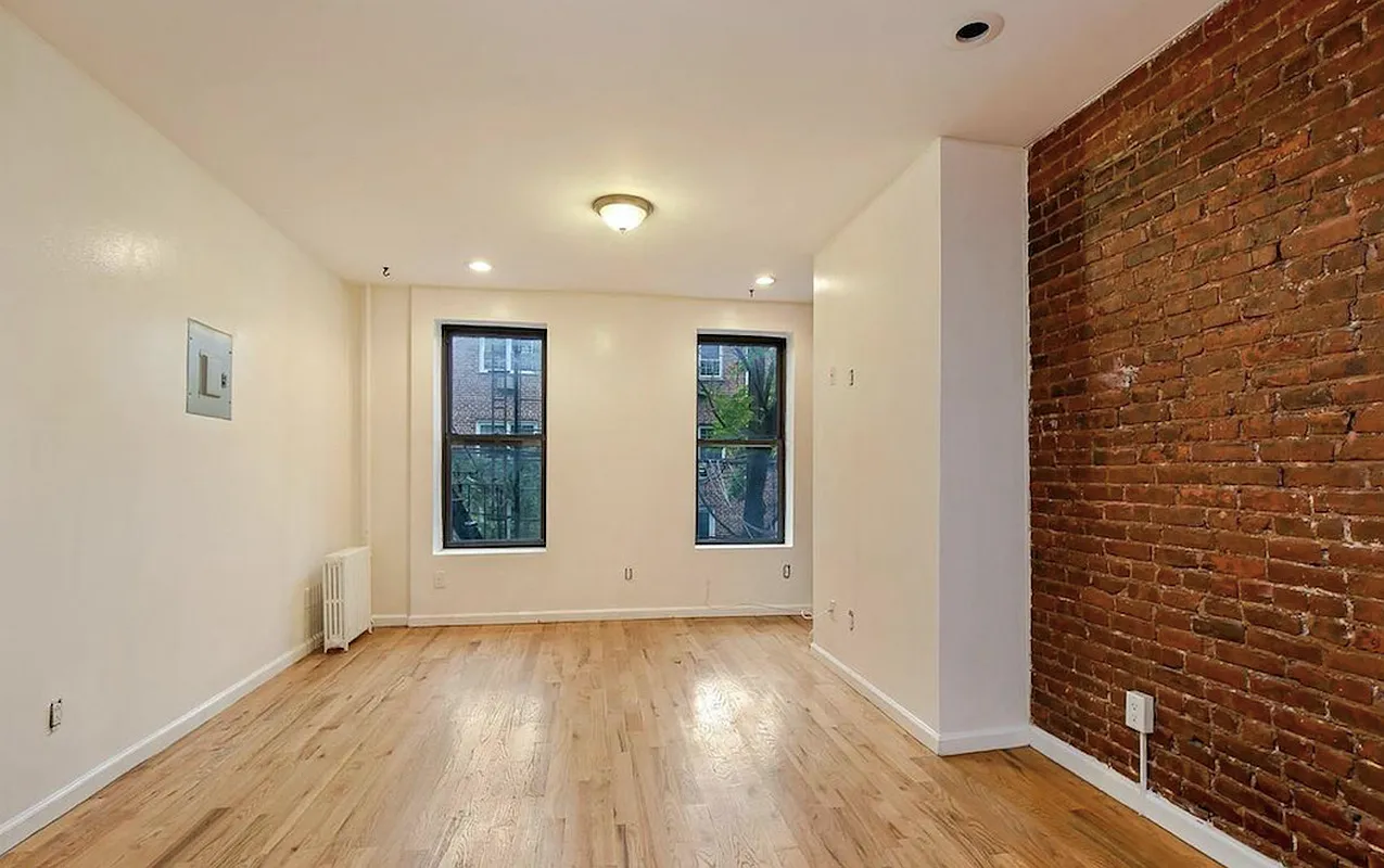 477 Hicks Street, Unit 2R Brooklyn, NY 11231 - Photo 5 of 7 a view of an empty room with wooden floor and a window